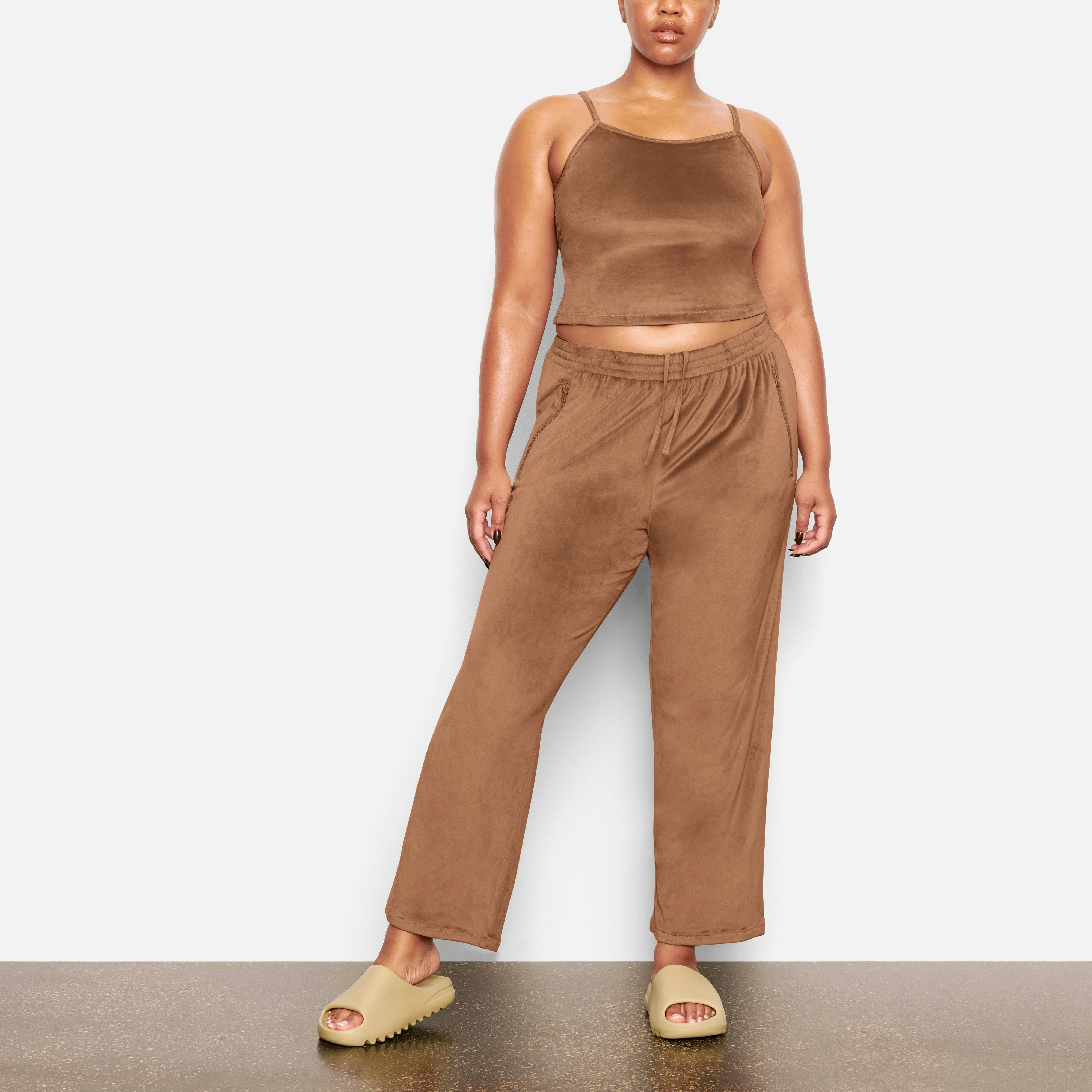 FRONT VIEW OF THE VELOUR TRACK PANT ON A MODEL
