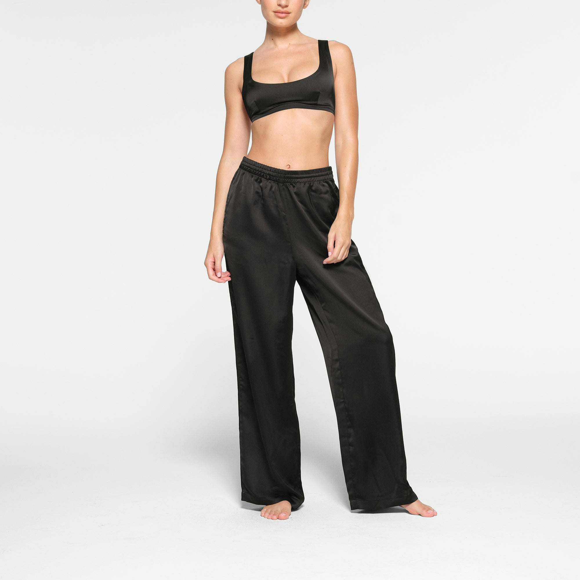 SKIMS SPORTY SATIN STRAIGHT LEG PANT WORN BY A MODEL IN FRONT VIEW