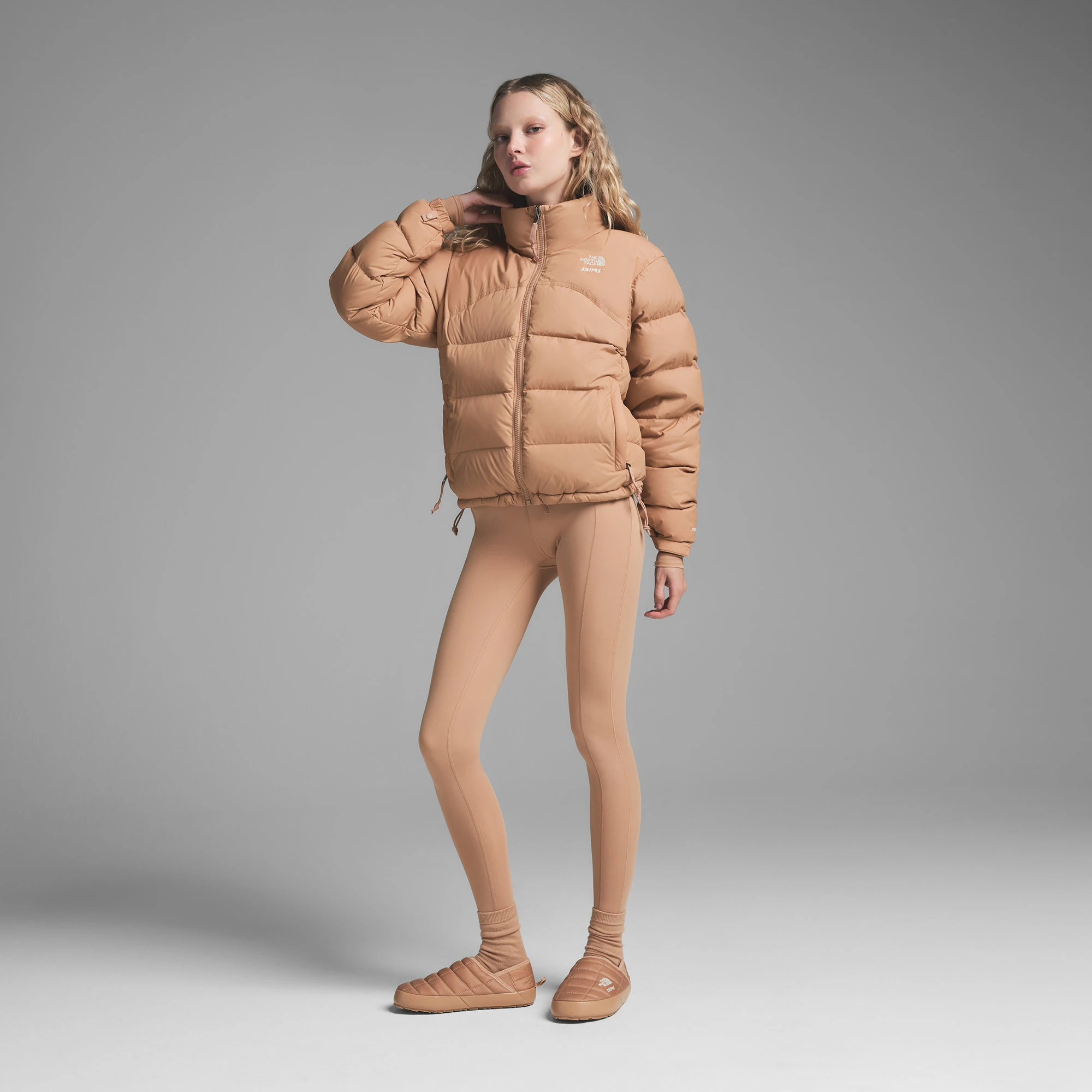 THE NORTH FACE X SKIMS ON A MODEL FRONT VIEW000 RETRO NUPTSE JACKET | OCHRE ON A MODEL SIDE VIEW