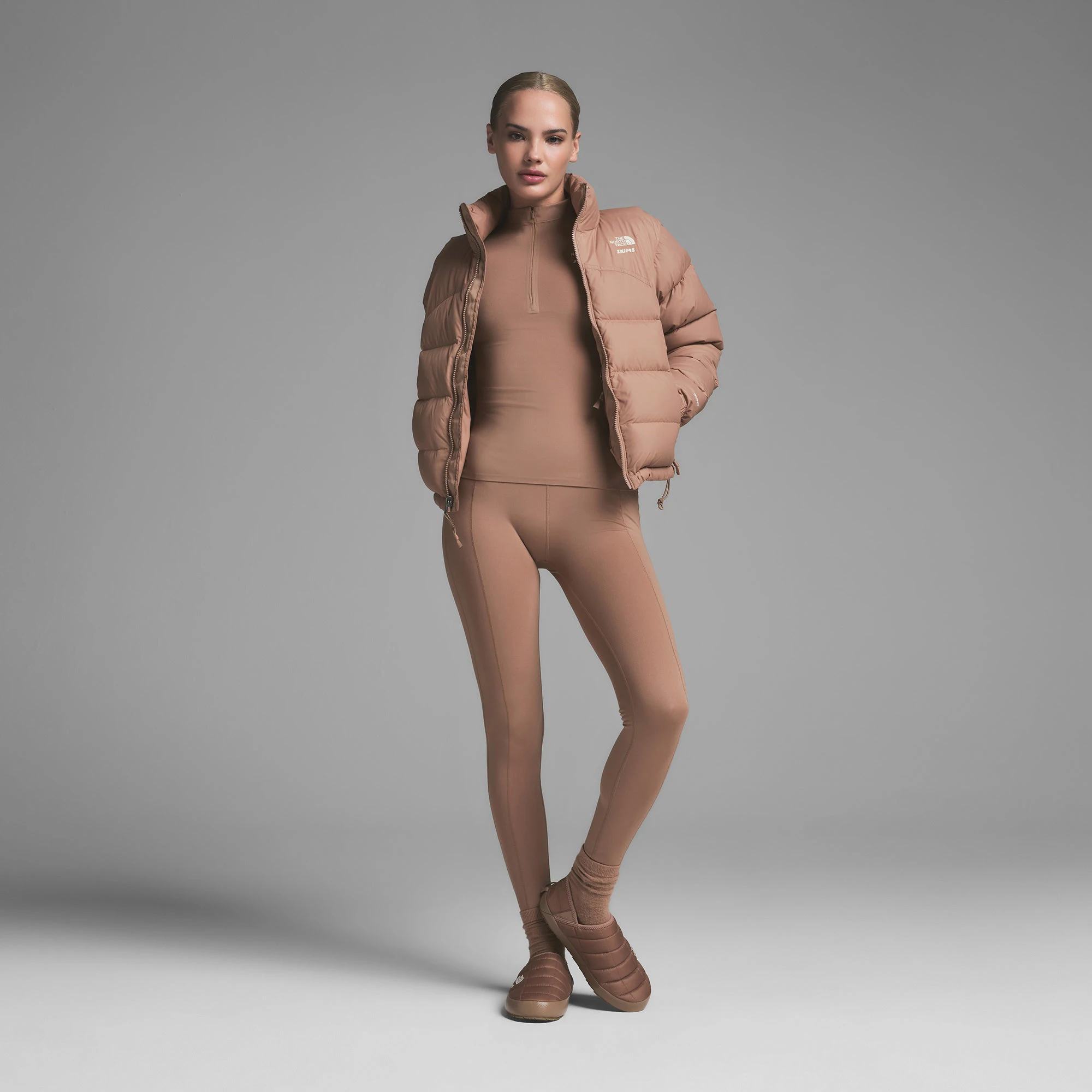 THE NORTH FACE X SKIMS ON A MODEL FRONT VIEW000 RETRO NUPTSE JACKET | SIENNA ON A MODEL FRONT VIEW