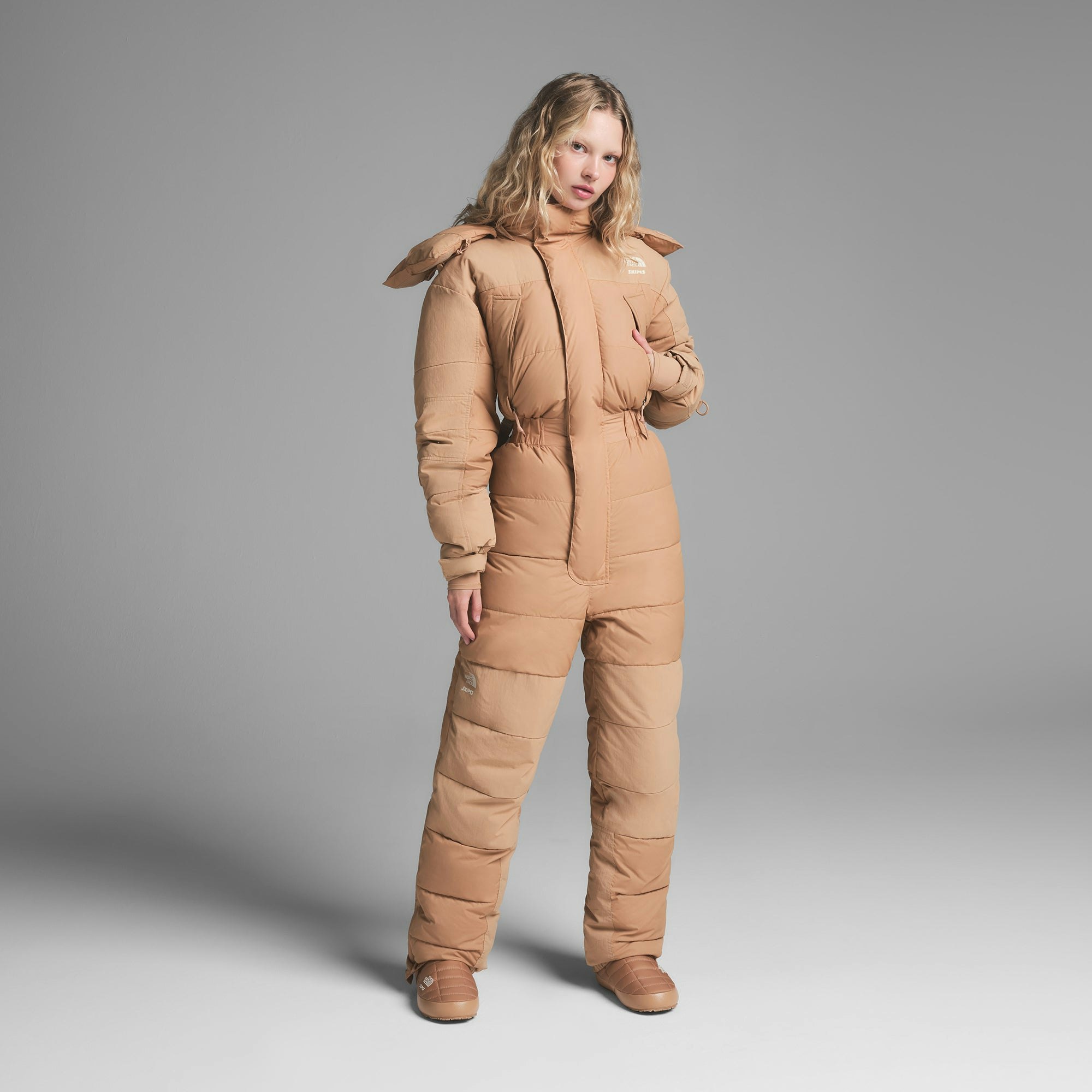 THE NORTH FACE X SKIMS DOWN ONE PIECE | OCHRE ON A MODEL FRONT VIEW | FOCUS: 0.0, 1.0, 0.9
