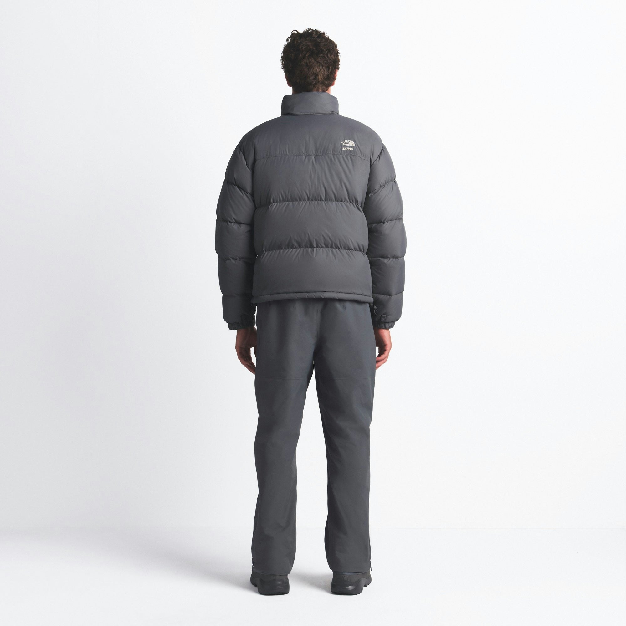 THE NORTH FACE X SKIMS 1996 NUPTSE JACKET | GUNMETAL ON A MODEL FRONT VIEW @ | FOCUS: 0.0, 1.0, 0.9