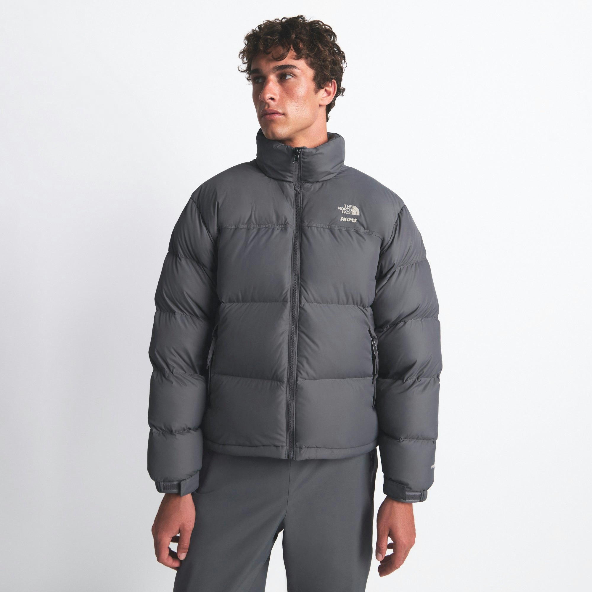 THE NORTH FACE X SKIMS 1996 NUPTSE JACKET | GUNMETAL ON A MODEL FRONT VIEW @ | FOCUS: 0.0, 1.0, 0.9