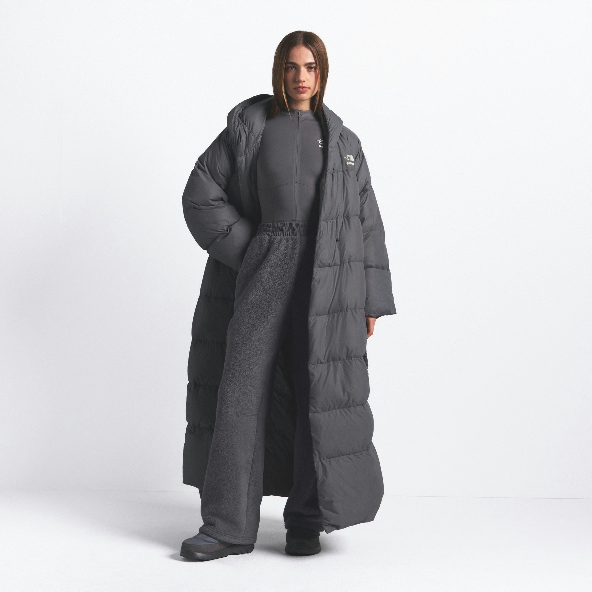 THE NORTH FACE X SKIMS NUPTSE WRAP PARKA | GUNMETAL ON A MODEL FRONT VIEW @ | FOCUS: 0.0, 1.0, 0.9