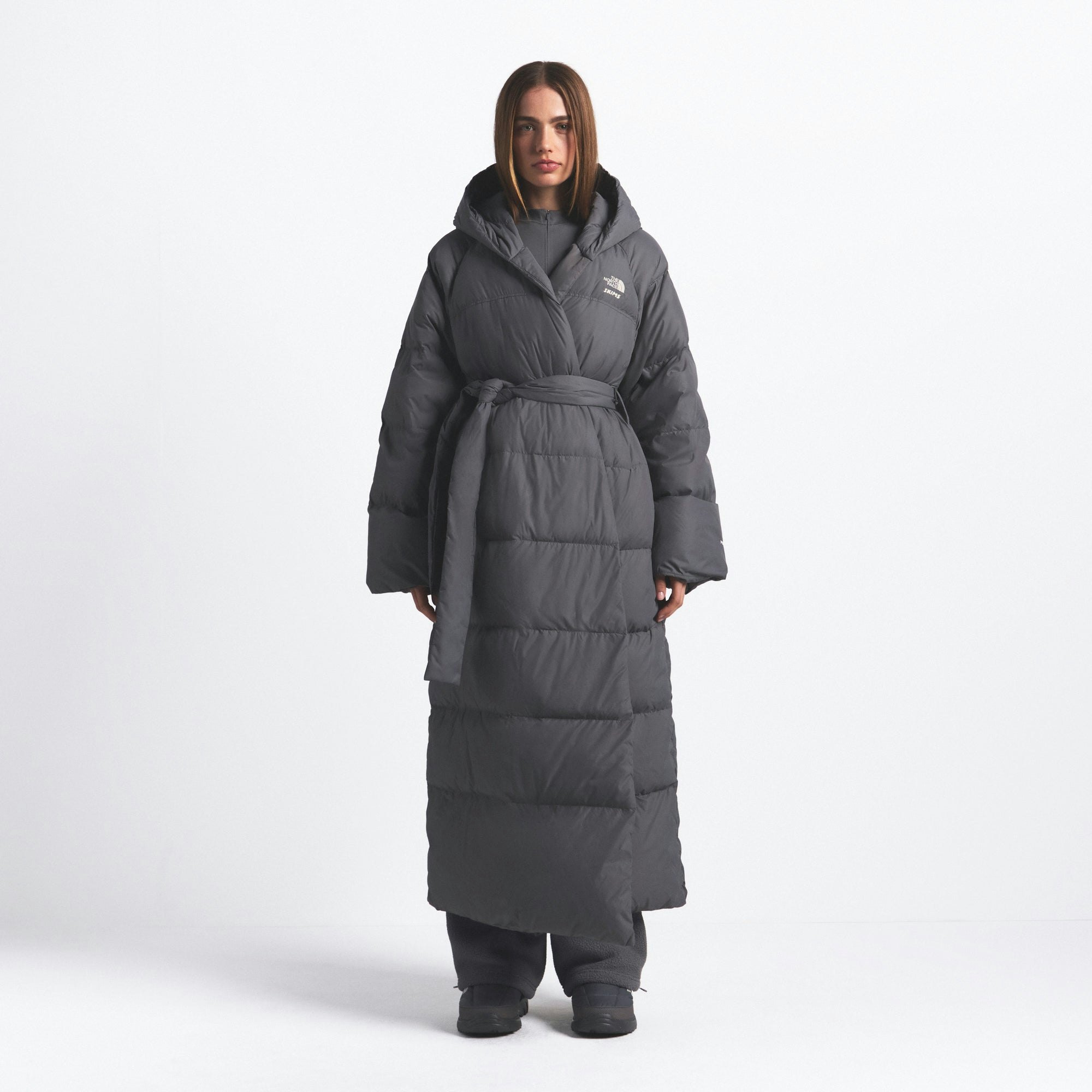 THE NORTH FACE X SKIMS NUPTSE WRAP PARKA | GUNMETAL ON A MODEL FRONT VIEW @ | FOCUS: 0.0, 1.0, 0.9