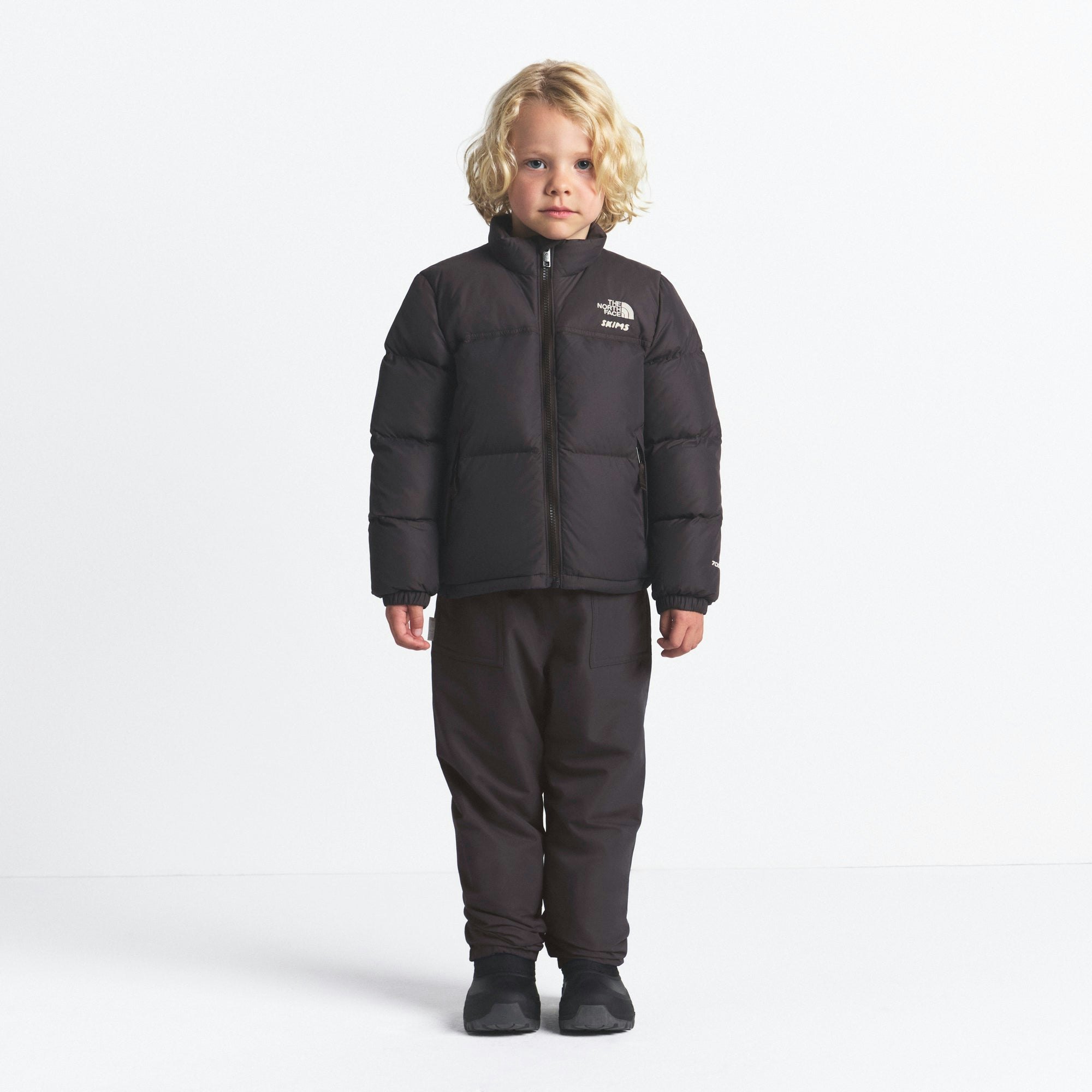 THE NORTH FACE X SKIMS KIDS' 1996 NUPTSE JACKET | PHOENIX ON A MODEL FRONT VIEW @ | FOCUS: 0.0, 1.0, 0.9