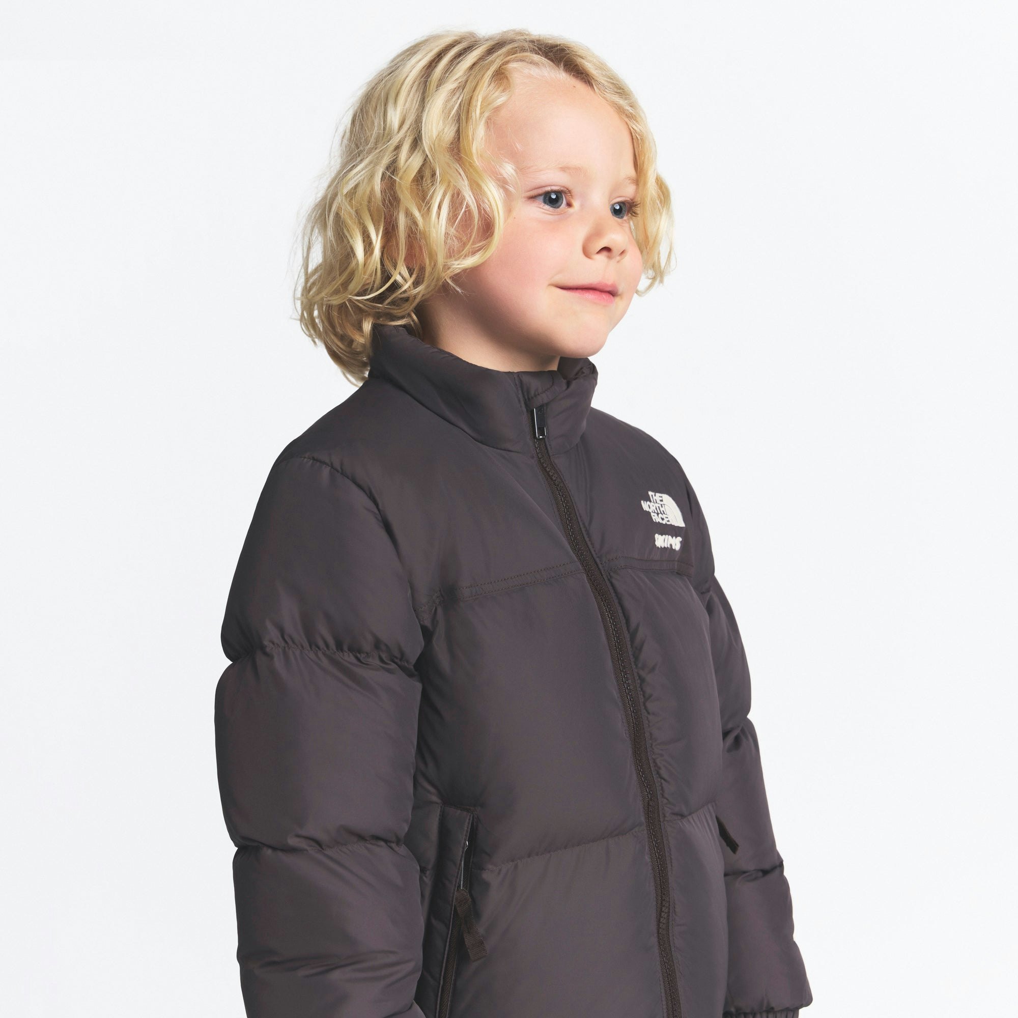 THE NORTH FACE X SKIMS KIDS' 1996 NUPTSE JACKET | PHOENIX ON A MODEL FRONT VIEW @ | FOCUS: 0.0, 1.0, 0.9