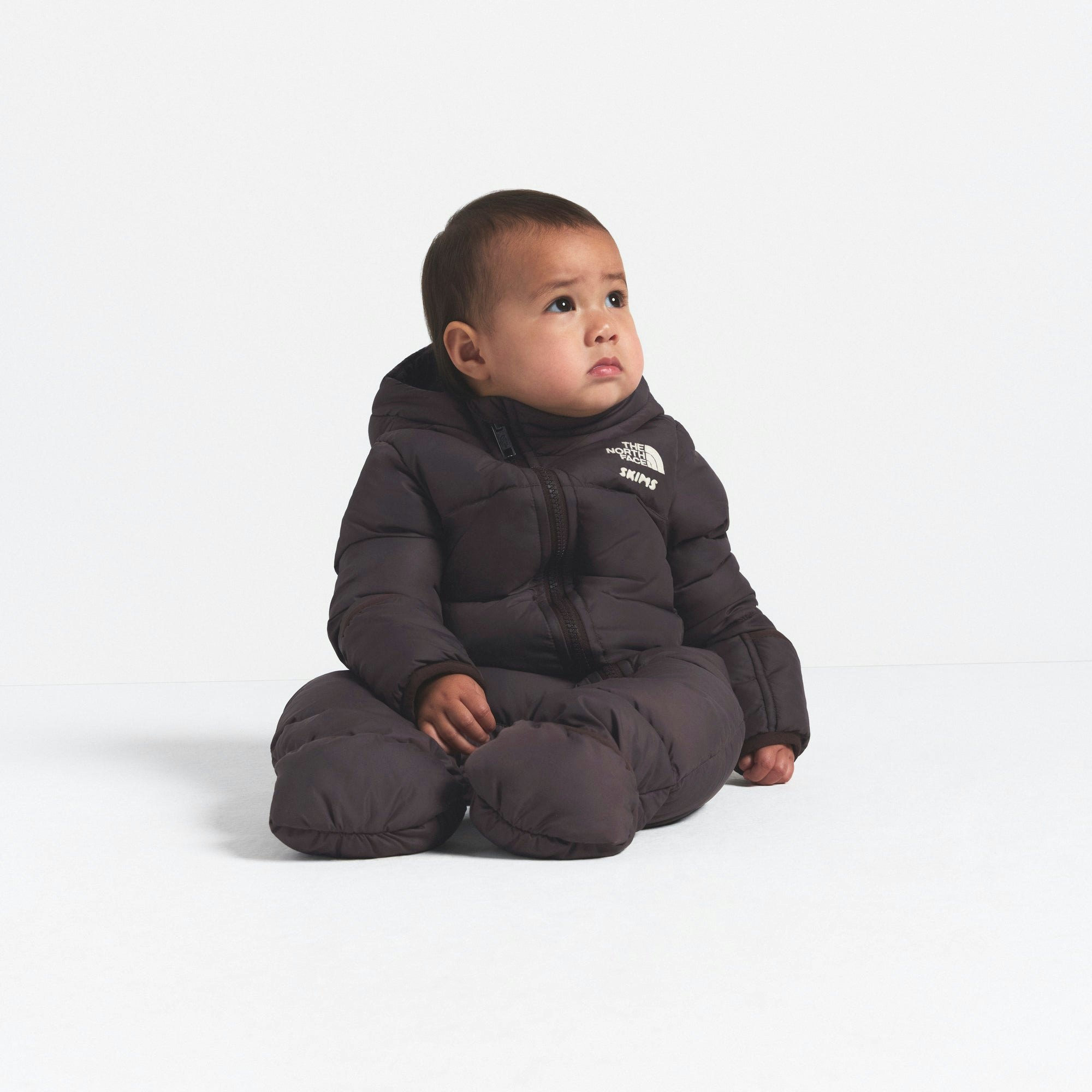 THE NORTH FACE X SKIMS BABY 1996 NUPTSE ONE-PIECE | PHOENIX ON A MODEL FRONT VIEW @ | FOCUS: 0.0, 1.0, 0.9