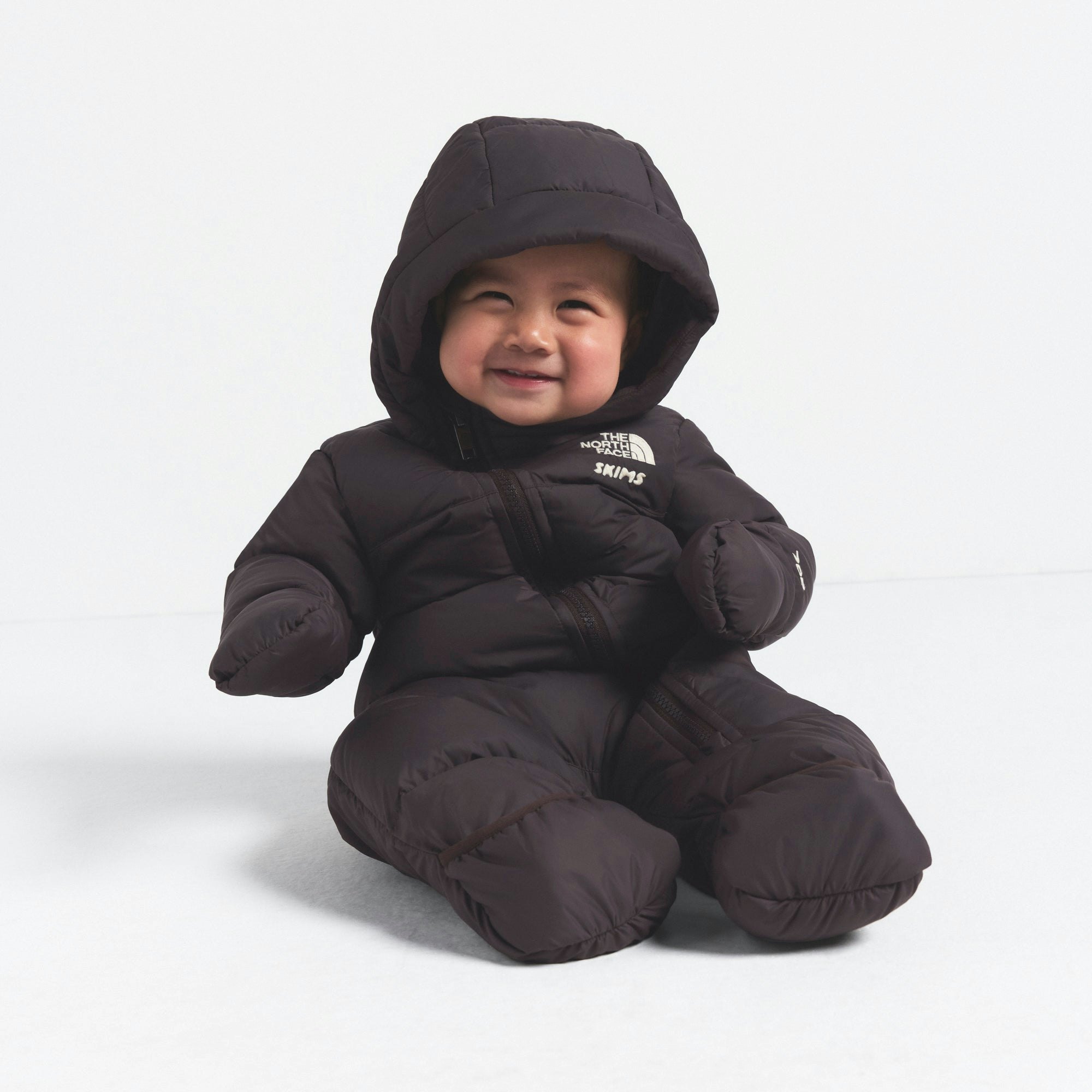 THE NORTH FACE X SKIMS BABY 1996 NUPTSE ONE-PIECE | PHOENIX ON A MODEL FRONT VIEW @ | FOCUS: 0.0, 1.0, 0.9