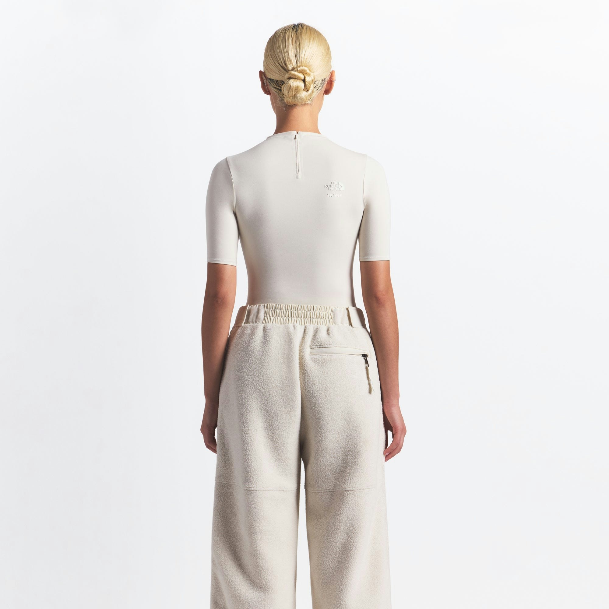 THE NORTH FACE X SKIMS 1995 DENALI FLEECE STRAIGHT LEG PANT | BONE ON A MODEL FRONT VIEW @ | FOCUS: 0.0, 1.0, 0.9