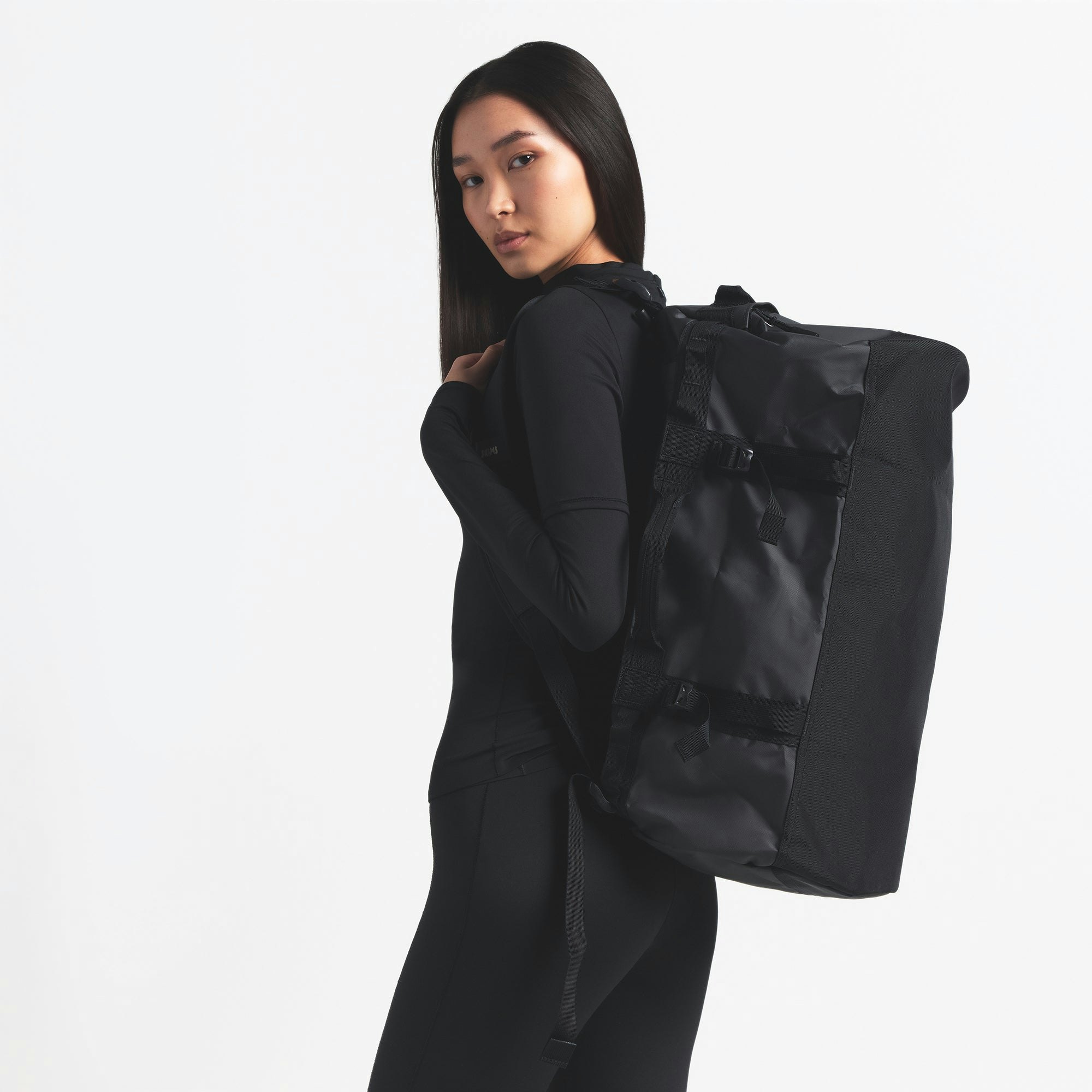 THE NORTH FACE X SKIMS SMALL BASE CAMP DUFFLE BAG | ONYX ON A MODEL BACK VIEW @ | FOCUS: 0.0, 1.0, 0.9