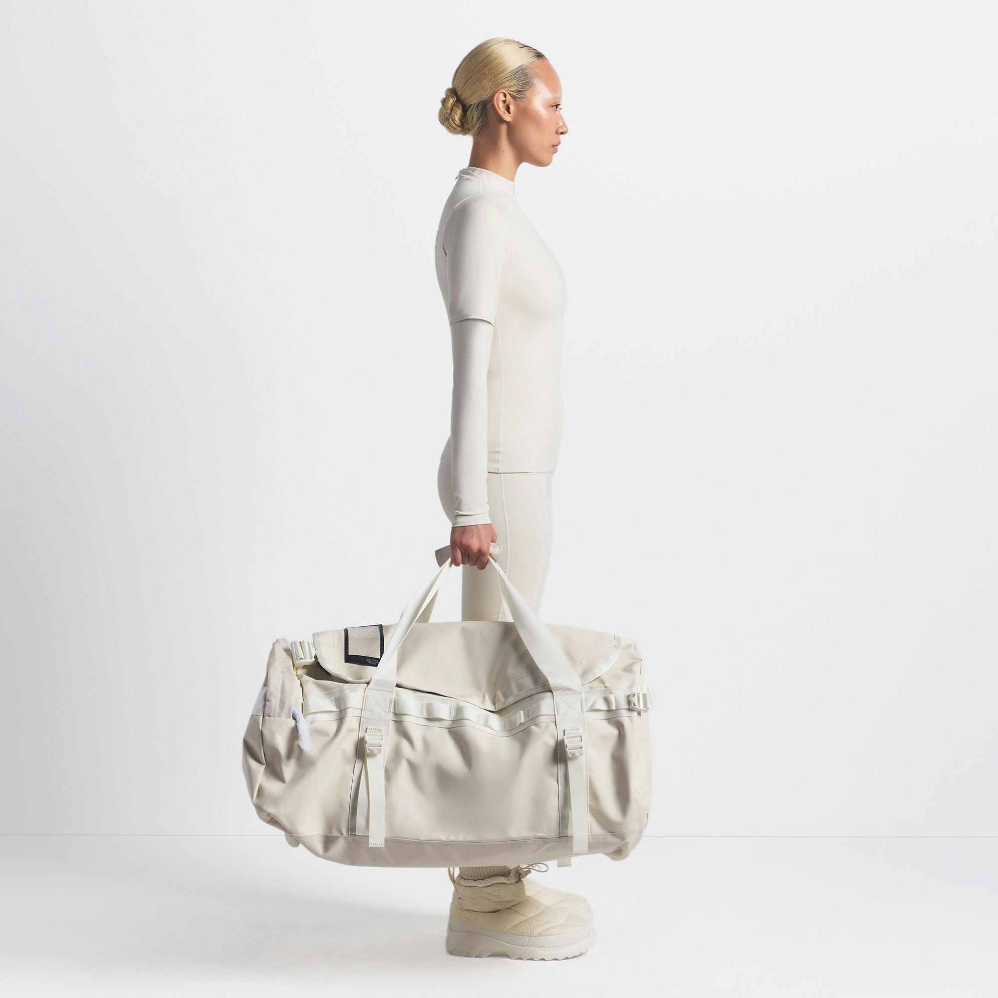 THE NORTH FACE X SKIMS LARGE BASE CAMP DUFFLE BAG | BONE ON A MODEL FRONT VIEW @ | FOCUS: 0.0, 1.0, 0.9