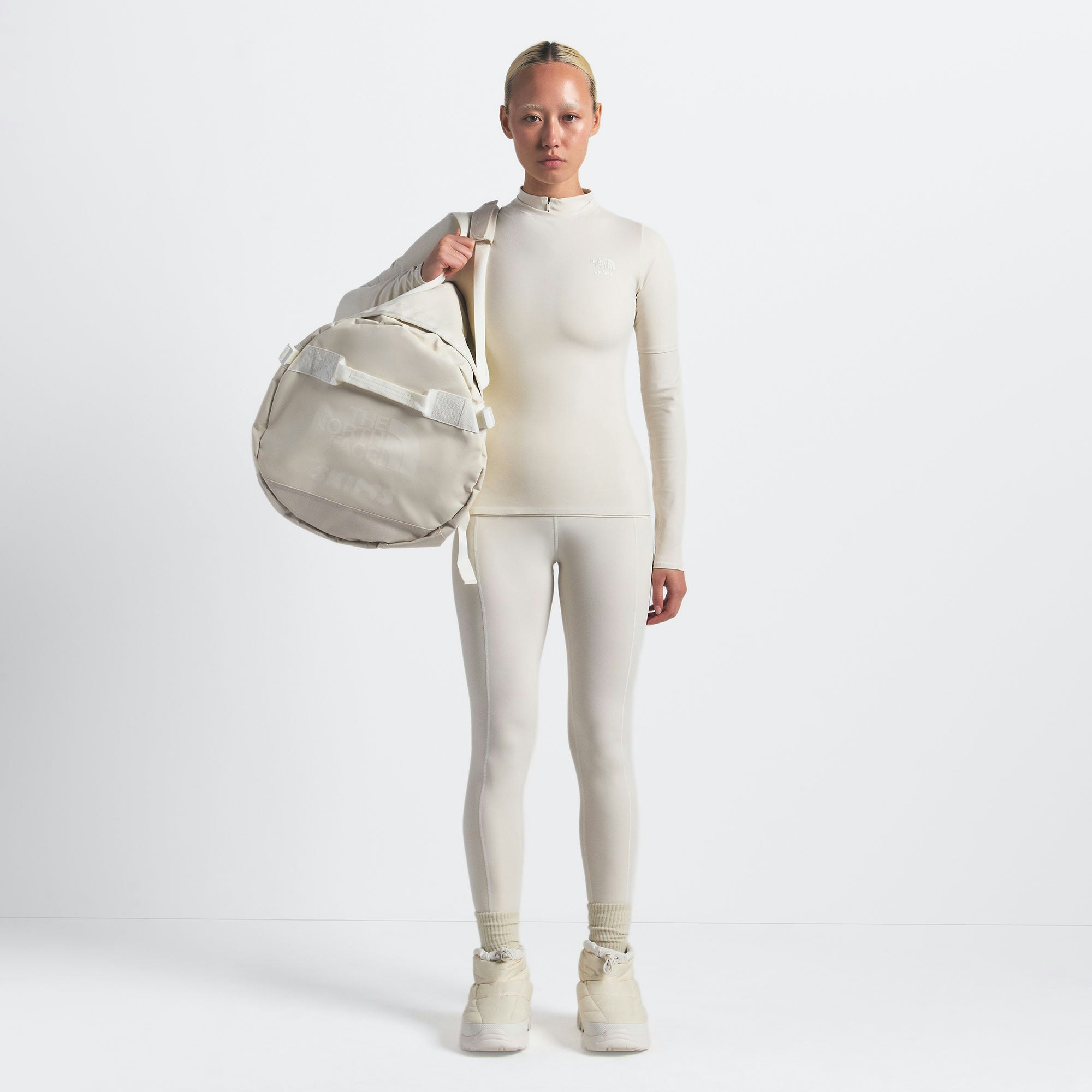 THE NORTH FACE X SKIMS LARGE BASE CAMP DUFFLE BAG | BONE ON A MODEL FRONT VIEW @ | FOCUS: 0.0, 1.0, 0.9