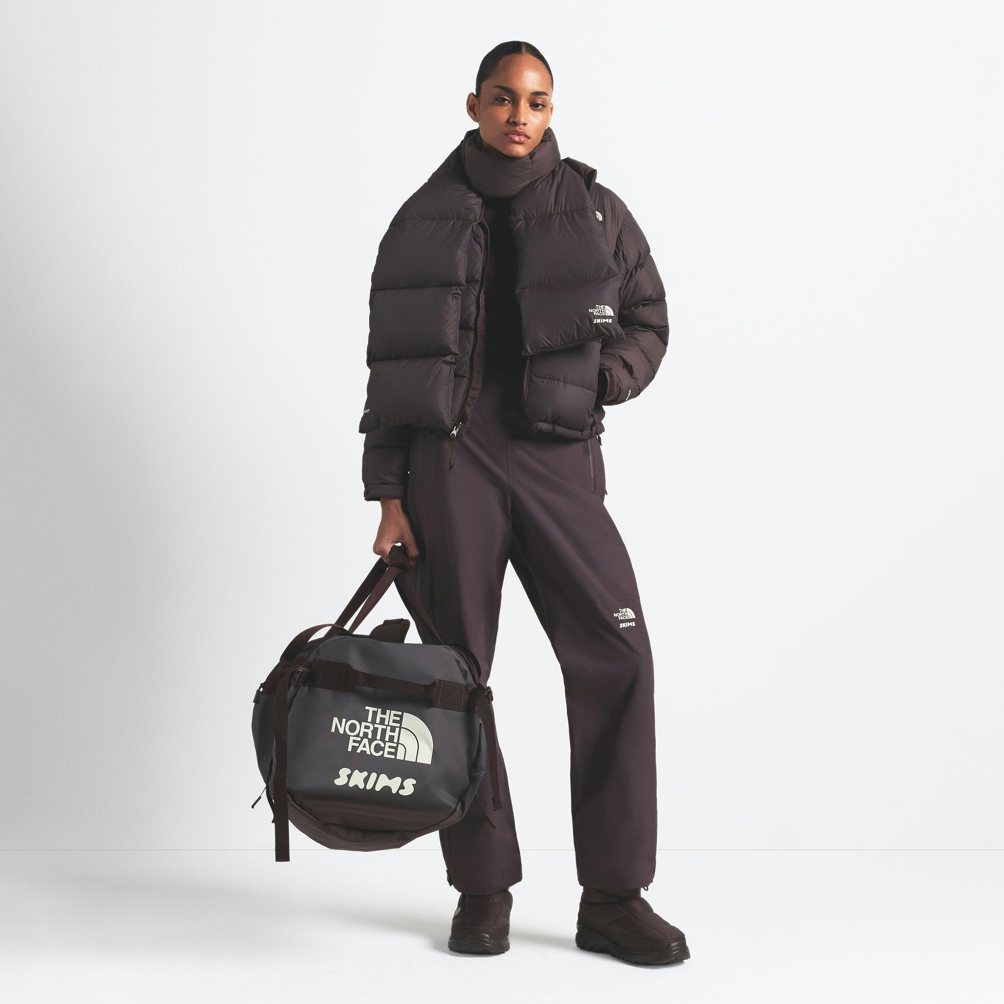 THE NORTH FACE X SKIMS LARGE BASE CAMP DUFFLE BAG | PHOENIX ON A MODEL FRONT VIEW @ | FOCUS: 0.0, 1.0, 0.9