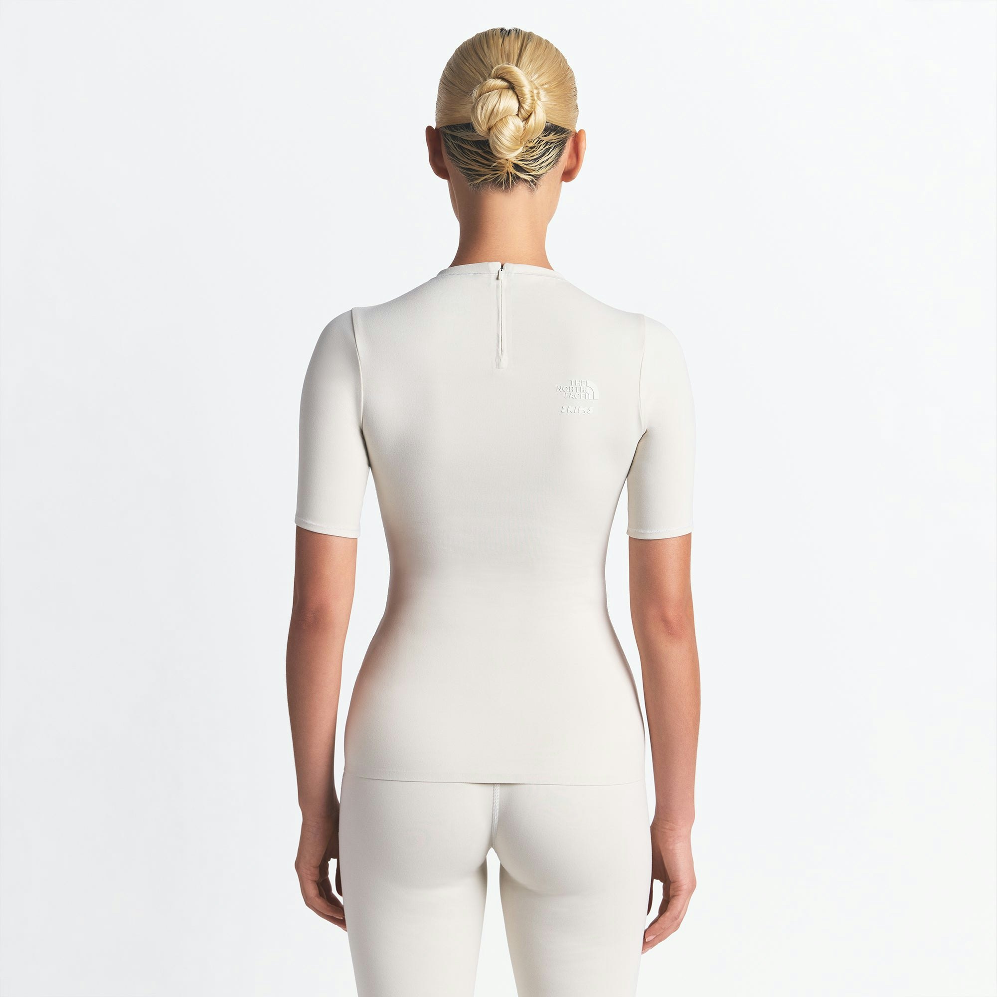 THE NORTH FACE X SKIMS REFINA SHORT SLEEVE TOP | BONE ON A MODEL FRONT VIEW @ | FOCUS: 0.0, 1.0, 0.9