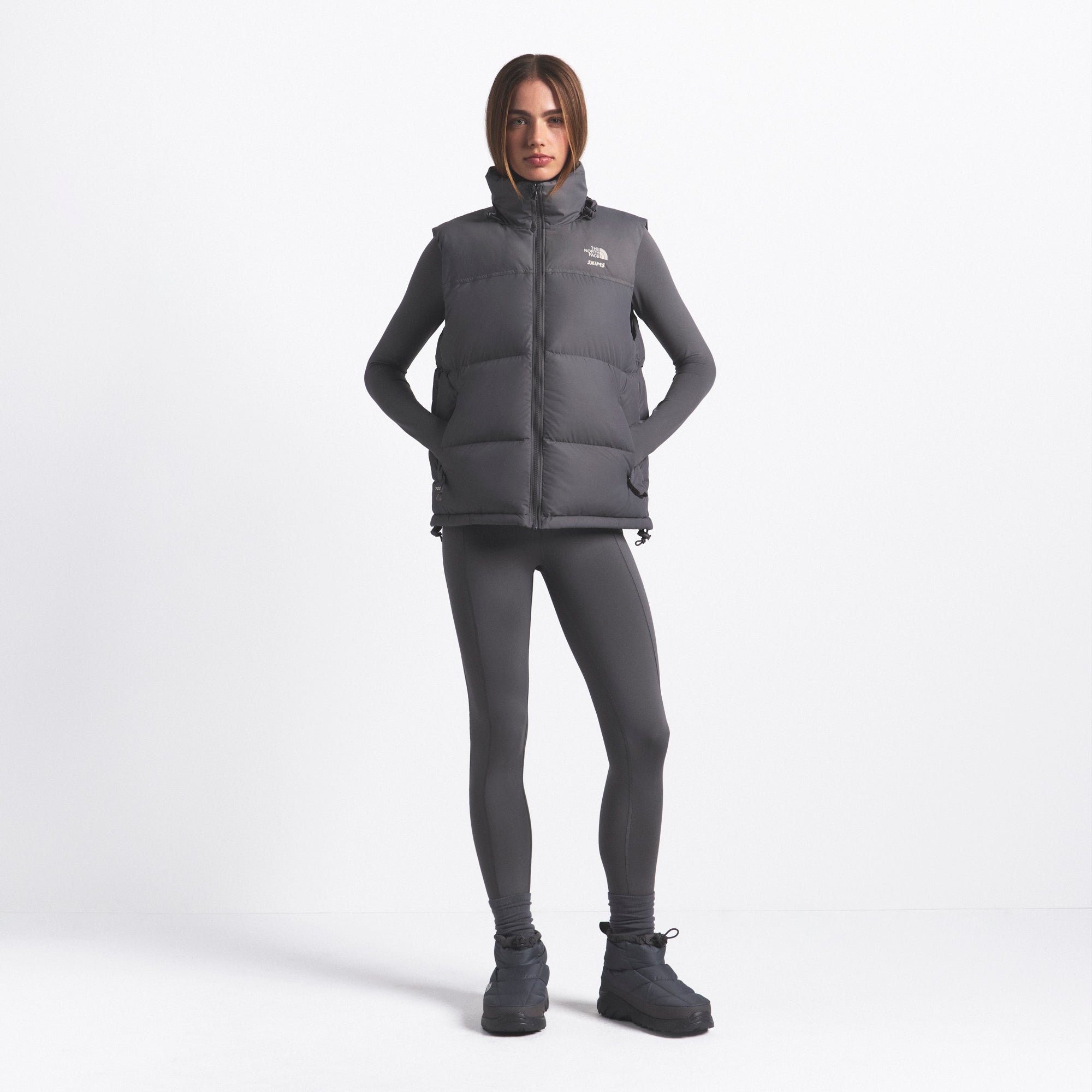 THE NORTH FACE X SKIMS 1996 NUPTSE VEST | GUNMETAL ON A MODEL FRONT VIEW @ | FOCUS: 0.0, 1.0, 0.9