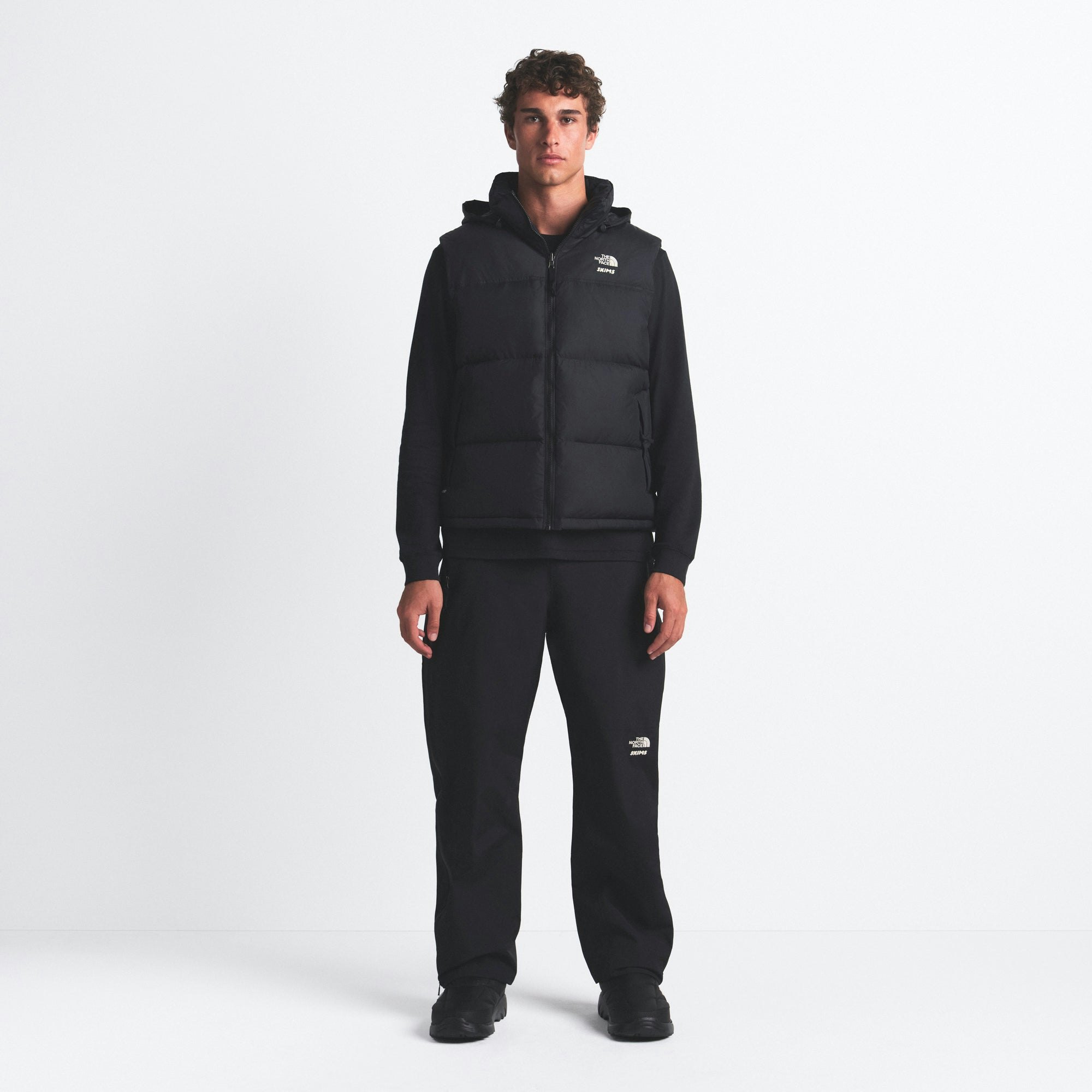 THE NORTH FACE X SKIMS 1996 NUPTSE VEST | ONYX ON A MODEL FRONT VIEW @ | FOCUS: 0.0, 1.0, 0.9