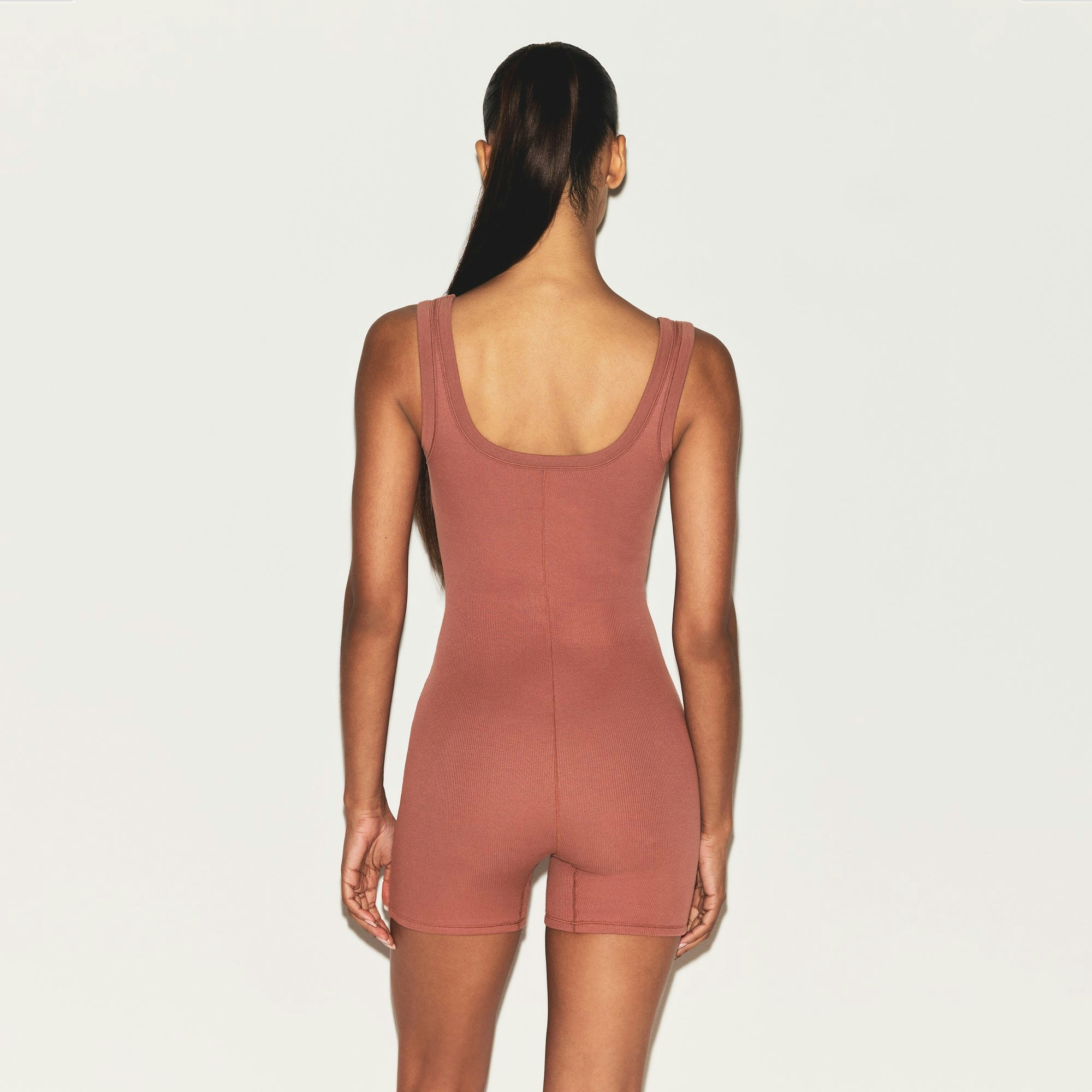 COTTON RIB ONESIE | REDWOOD ON A MODEL SIDE VIEW | FOCUS: 0.0, 1.0, 0.9