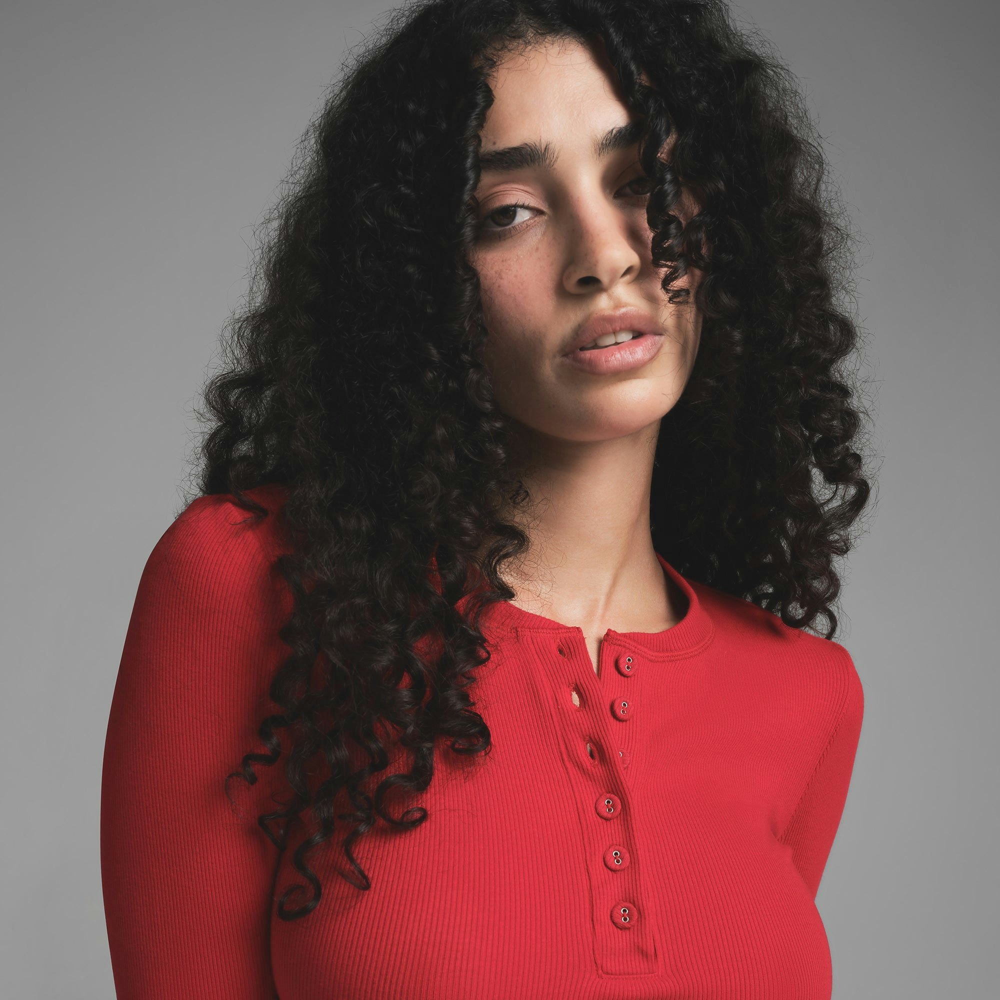 COTTON RIB LONG SLEEVE CROP HENLEY | CRANBERRY ON A MODEL SIDE VIEW