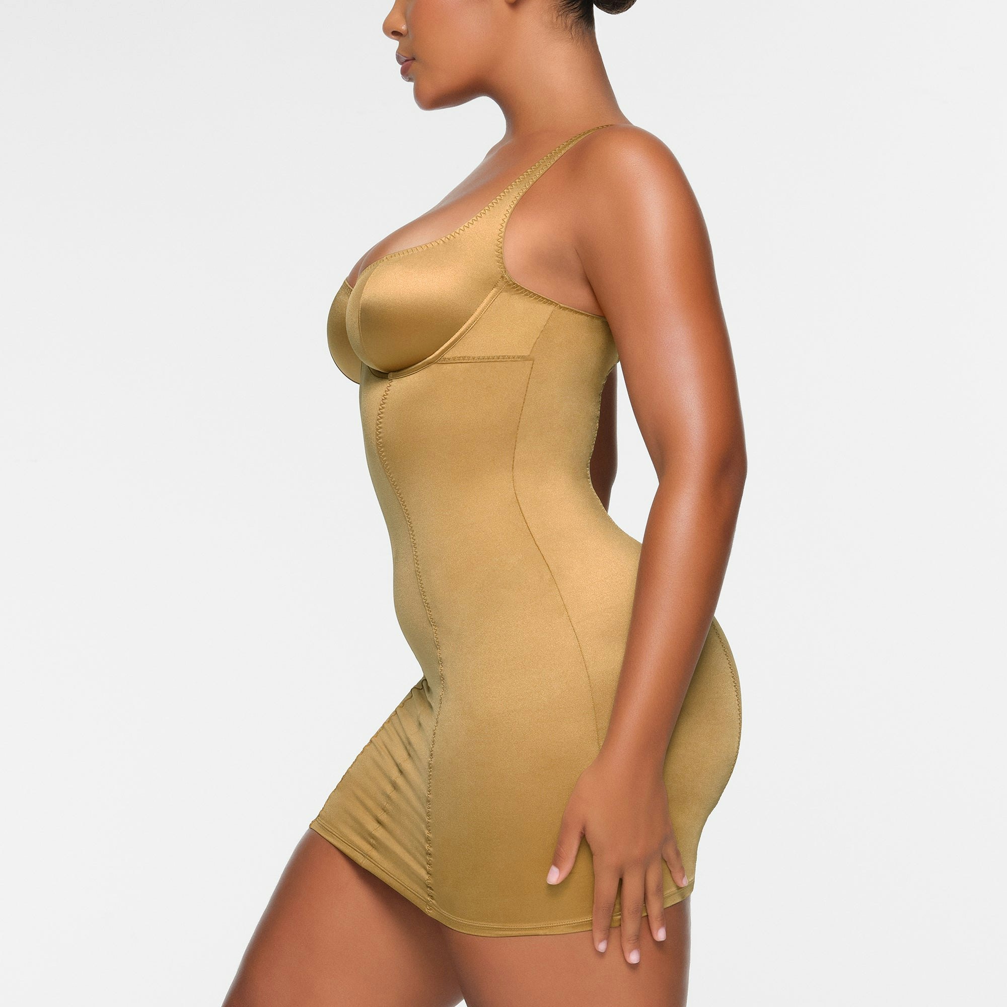 STRETCH SATIN MINI DRESS WORN BY A MODEL IN SIDE VIEW