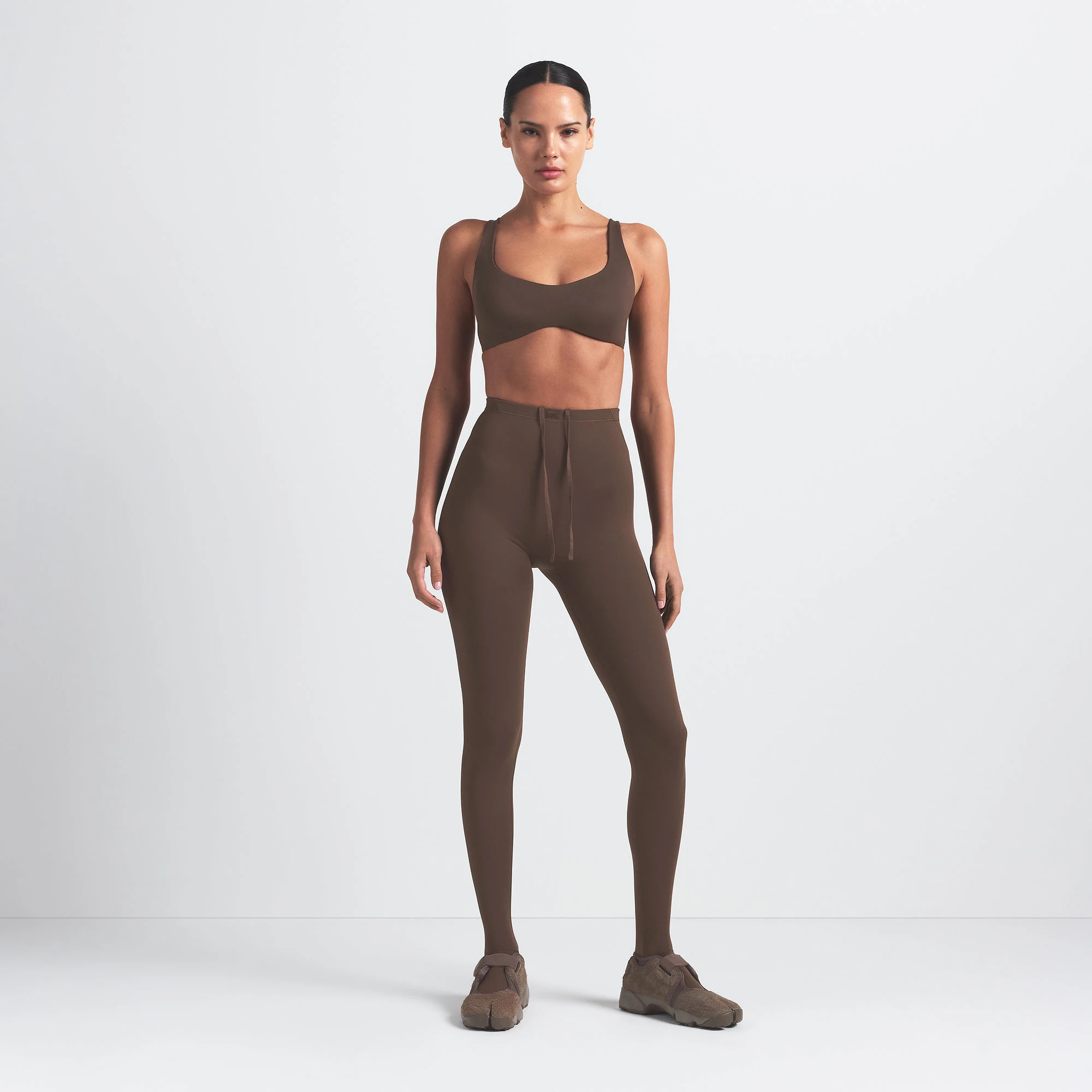 NikeSKIMS MATTE SHAPING SCOOP BRA | DARK SEPIA ON A MODEL FRONT VIEW @ | FOCUS: 0.0, 1.0, 0.9