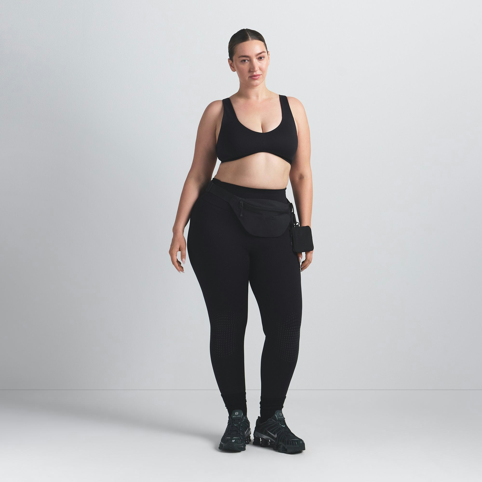 NikeSKIMS MATTE SHAPING SCOOP BRA | OBSIDIAN ON A MODEL FRONT VIEW @ | FOCUS: 0.0, 1.0, 0.9