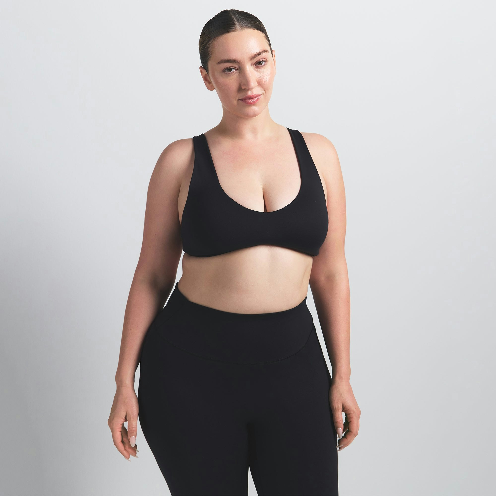 NikeSKIMS MATTE SHAPING SCOOP BRA | OBSIDIAN ON A MODEL FRONT VIEW @ | FOCUS: 0.0, 1.0, 0.9