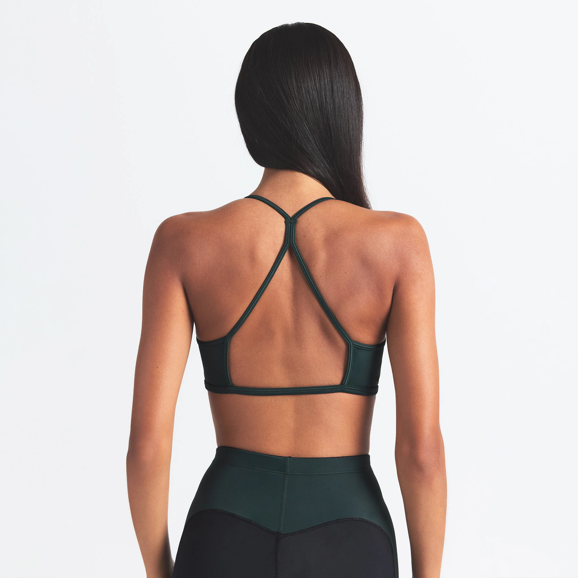 NikeSKIMS SHINE MICRO SCOOP BRA | OBSIDIAN AND DARK TEAL ON A MODEL BACK VIEW @ | FOCUS: 0.0, 1.0, 0.9