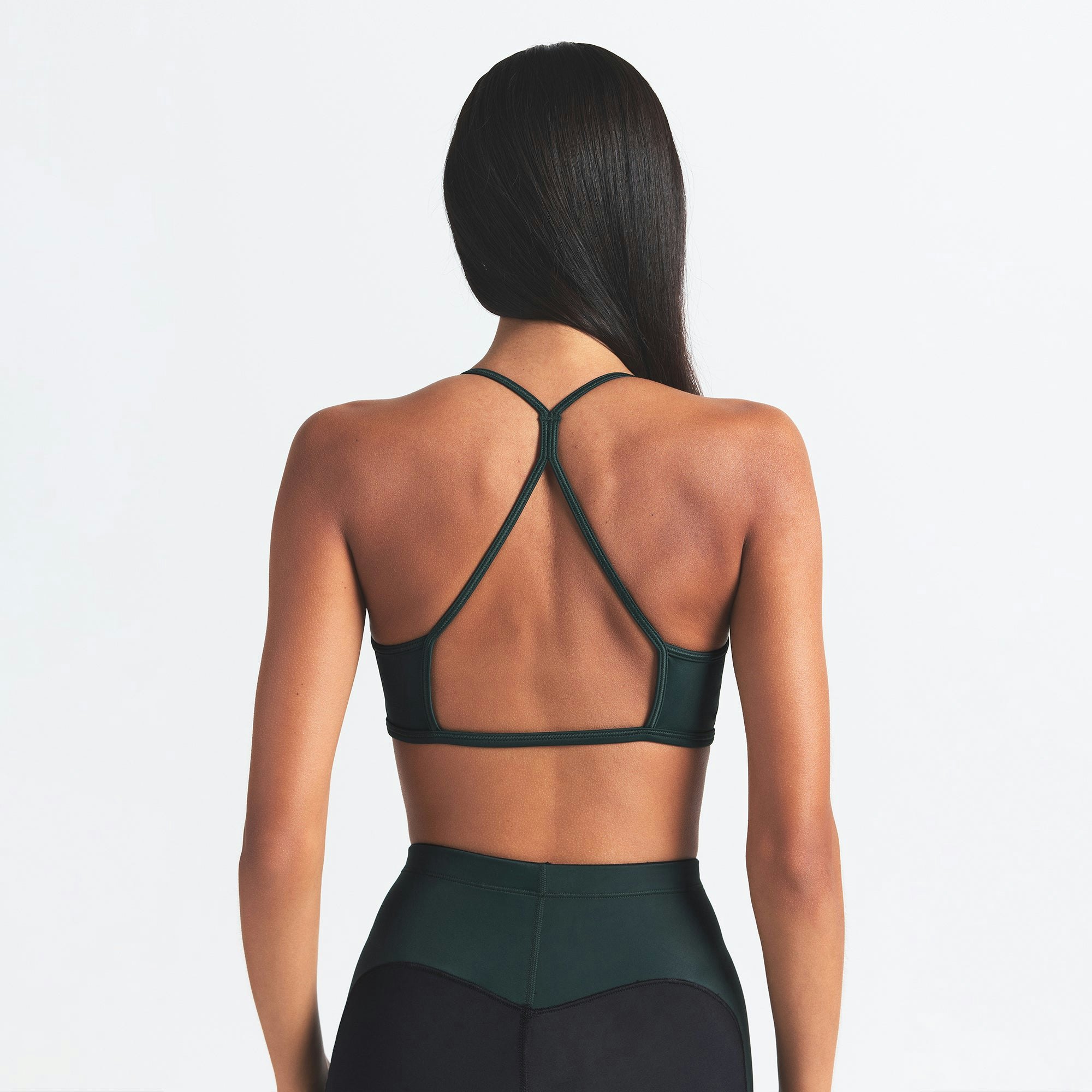 NikeSKIMS SHINE MICRO SCOOP BRA | OBSIDIAN AND DARK TEAL ON A MODEL BACK VIEW @ | FOCUS: 0.0, 1.0, 0.9