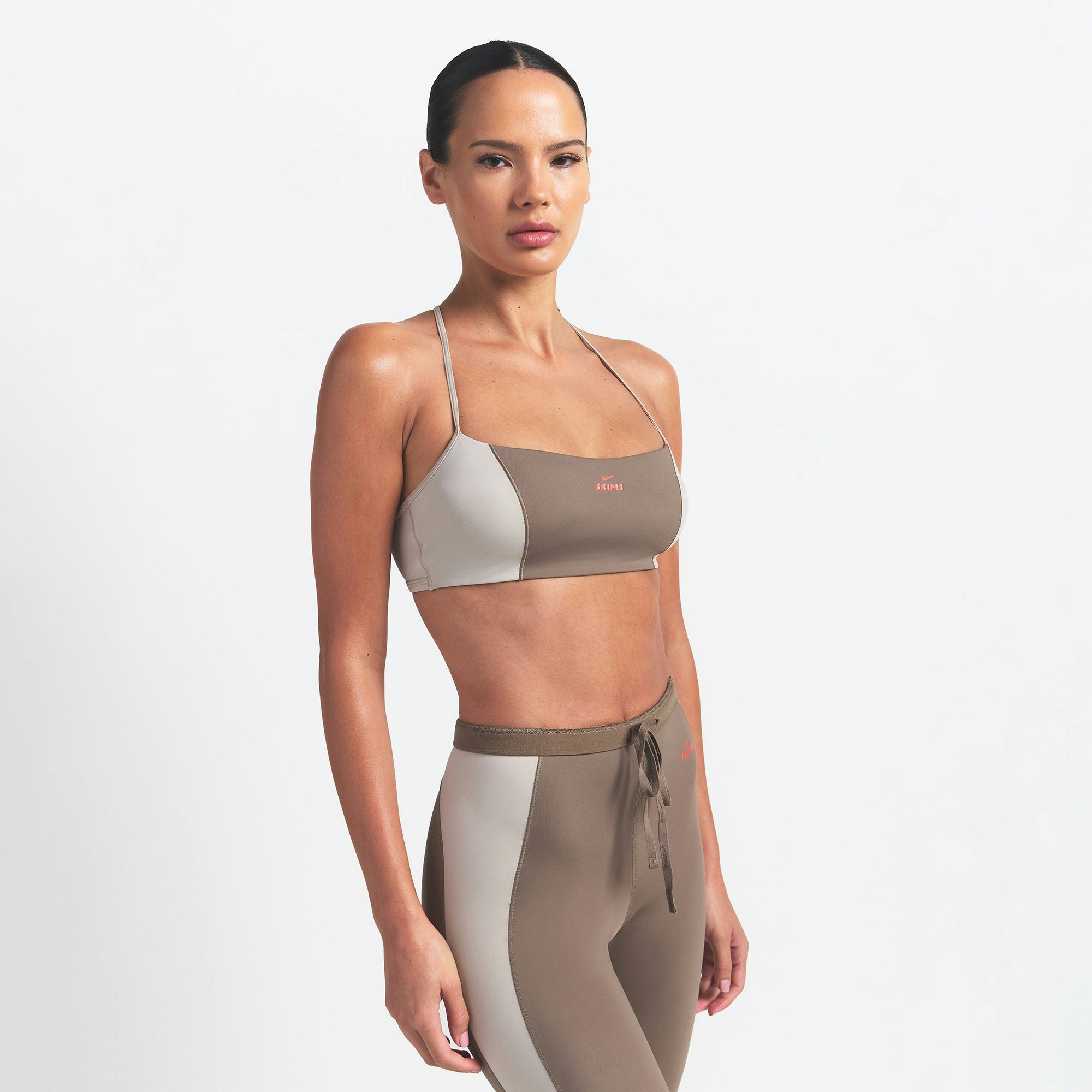 NikeSKIMS SHINE MICRO SCOOP BRA | TRUFFLE AND STONE ON A MODEL SIDE VIEW @ | FOCUS: 0.0, 1.0, 0.9