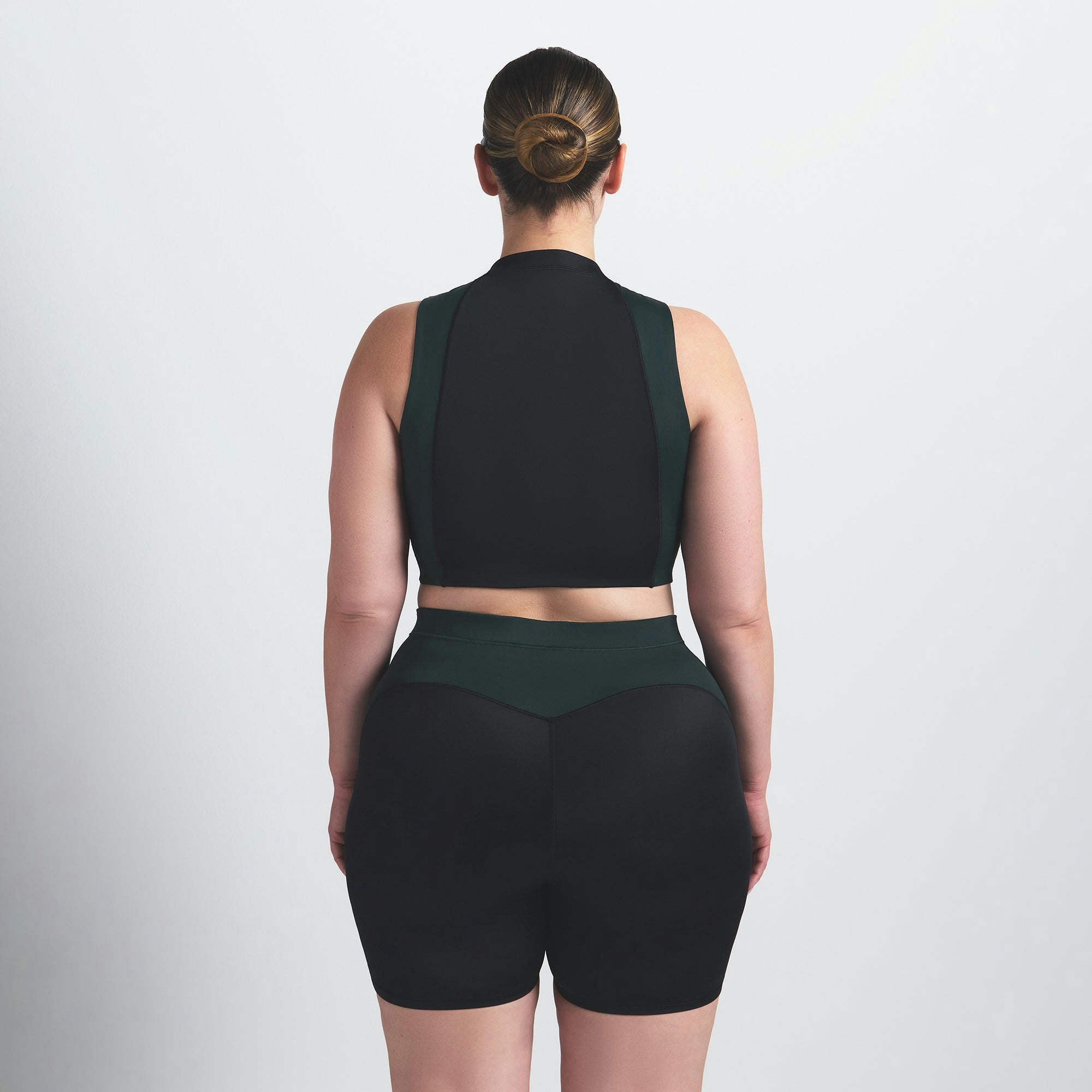 NikeSKIMS SHINE FRONT ZIP BRA | OBSIDIAN AND DARK TEAL ON A MODEL BACK VIEW @ | FOCUS: 0.0, 1.0, 0.9