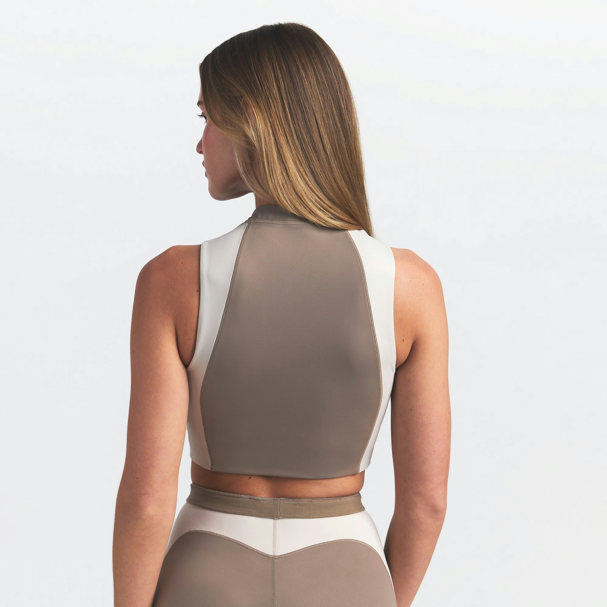 NikeSKIMS SHINE FRONT ZIP BRA | TRUFFLE AND STONE ON A MODEL BACK VIEW @ | FOCUS: 0.0, 1.0, 0.9