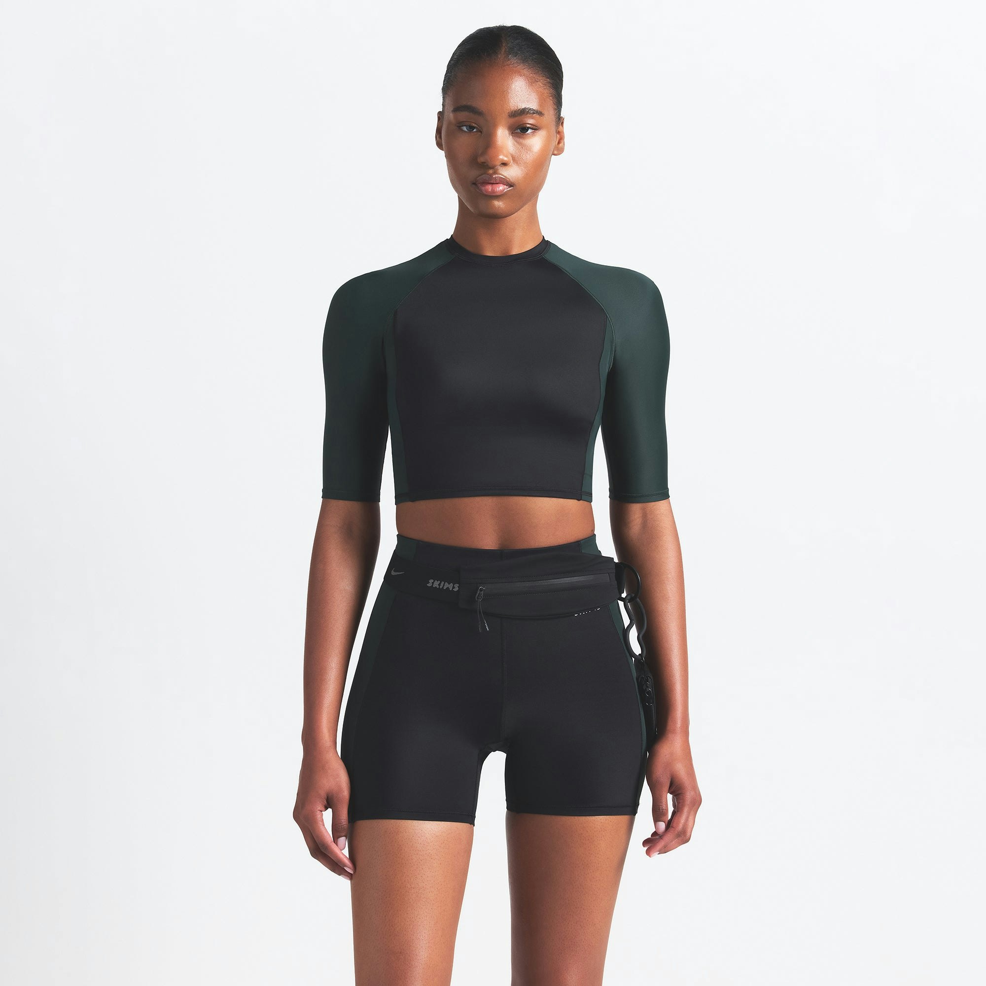 NikeSKIMS SHINE PADDED HALF SLEEVE CROP TOP | OBSIDIAN AND DARK TEAL ON A MODEL FRONT VIEW @ | FOCUS: 0.0, 1.0, 0.9