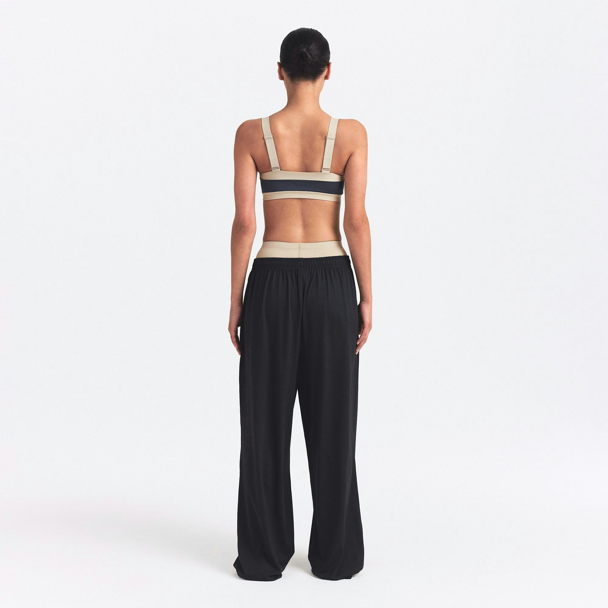 NikeSKIMS MATTE AND SHINE STRAIGHT NECK BRA | DEEP ROYAL/STONE ON A MODEL SIDE VIEW @ | FOCUS: 0.0, 1.0, 0.9