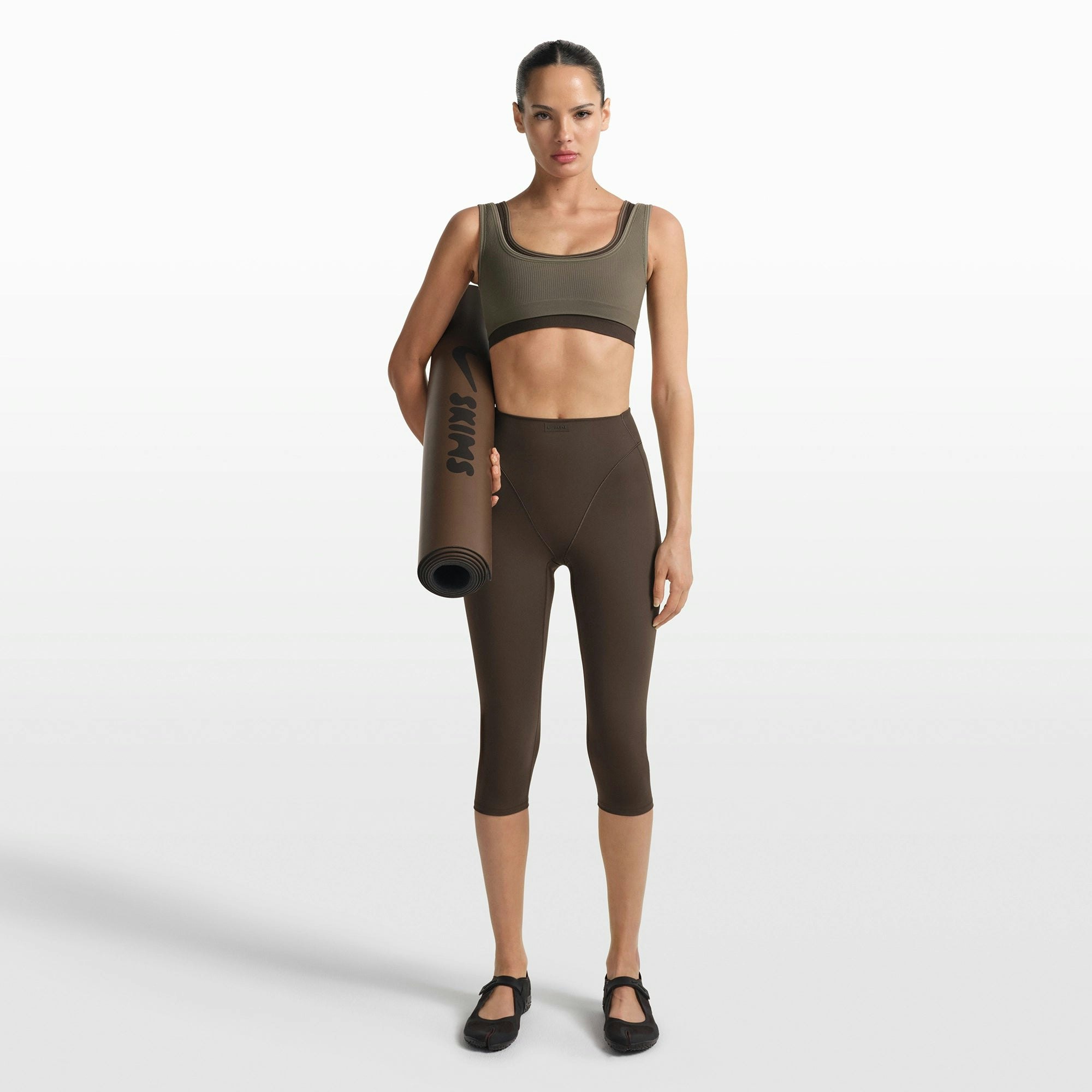 NikeSKIMS RIBBED SEAMLESS MICRO SCOOP BRA | DUSTY OAKMOSS/DUNE ON A MODEL FRONT VIEW @ | FOCUS: 0.0, 1.0, 0.9