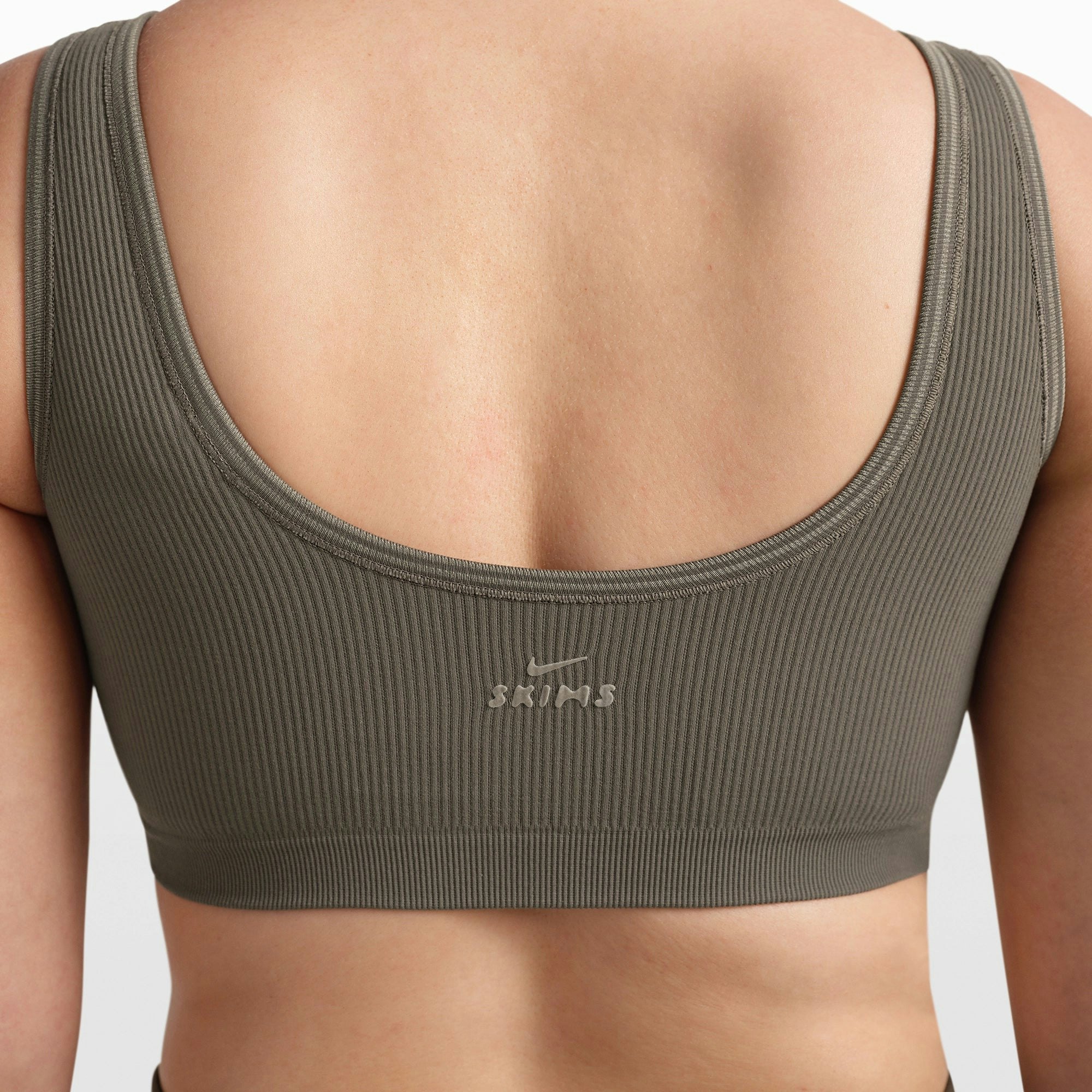 NikeSKIMS RIBBED SEAMLESS SCOOP BRA | DUSTY OAKMOSS/DUNE ON A MODEL FRONT VIEW @ | FOCUS: 0.0, 1.0, 0.9