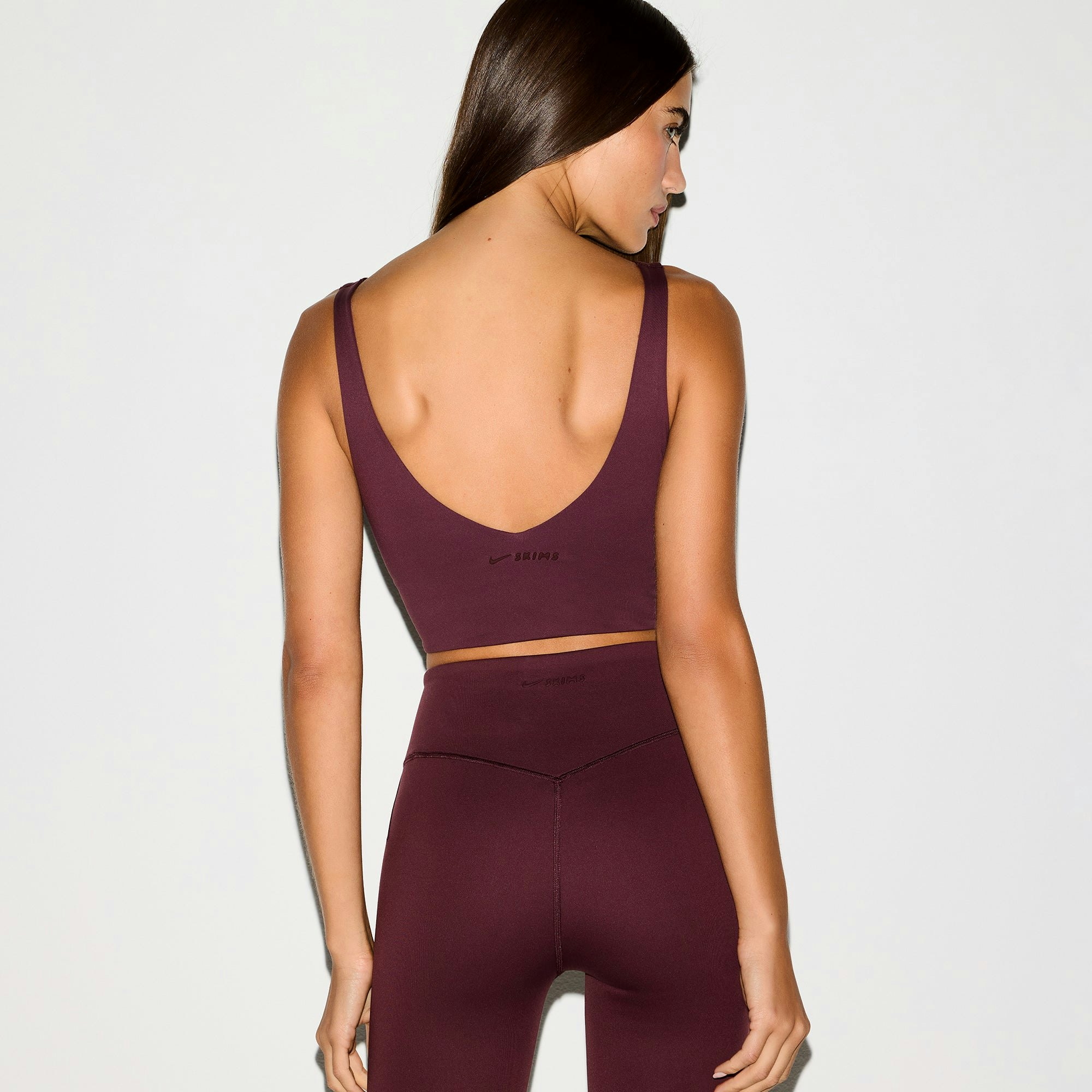 NikeSKIMS MATTE V-NECK BRA TOP | CURRANT ON A MODEL BACK VIEW @ | FOCUS: 0.0, 1.0, 0.9