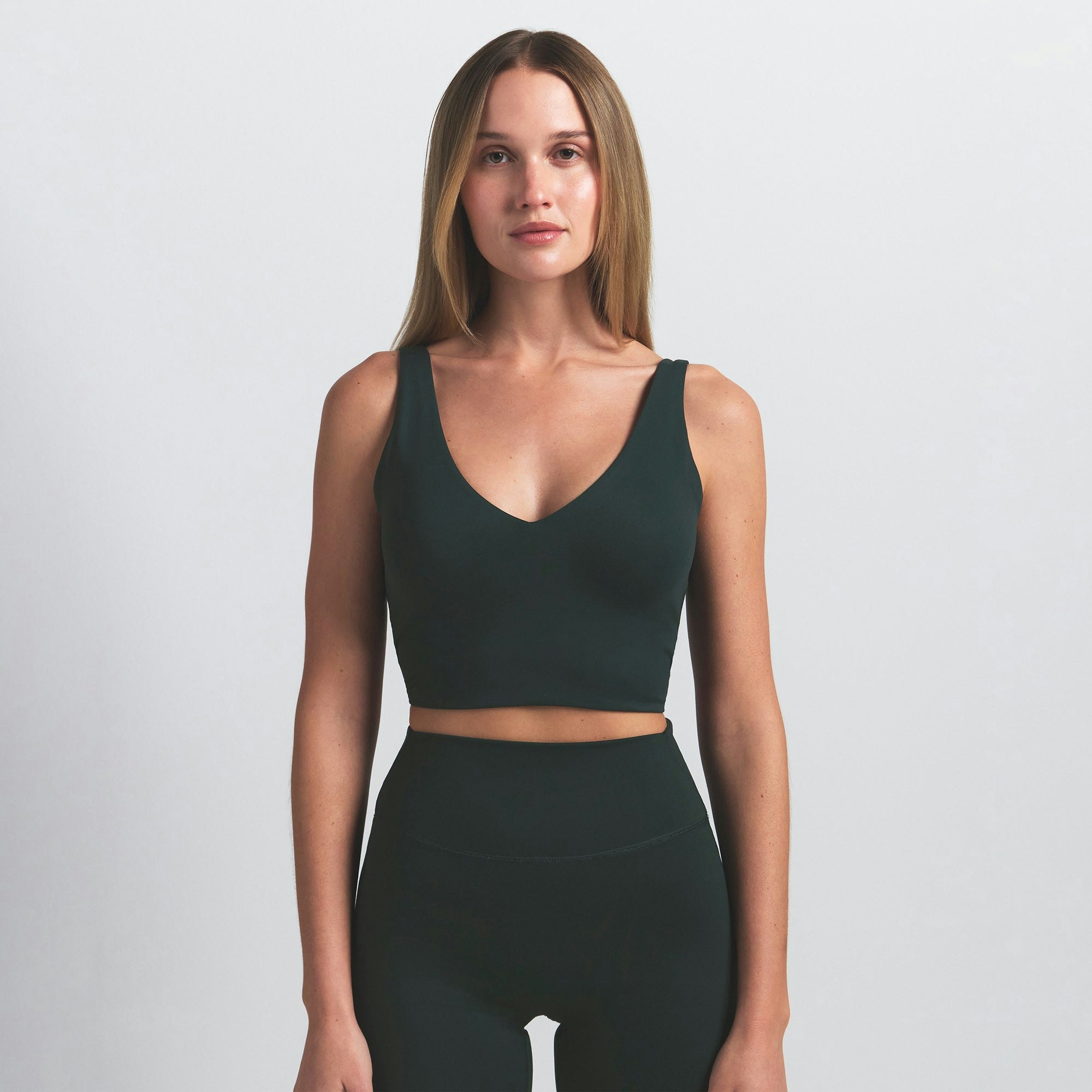 NikeSKIMS MATTE V-NECK BRA TOP | DARK TEAL ON A MODEL SIDE VIEW @ | FOCUS: 0.0, 1.0, 0.9