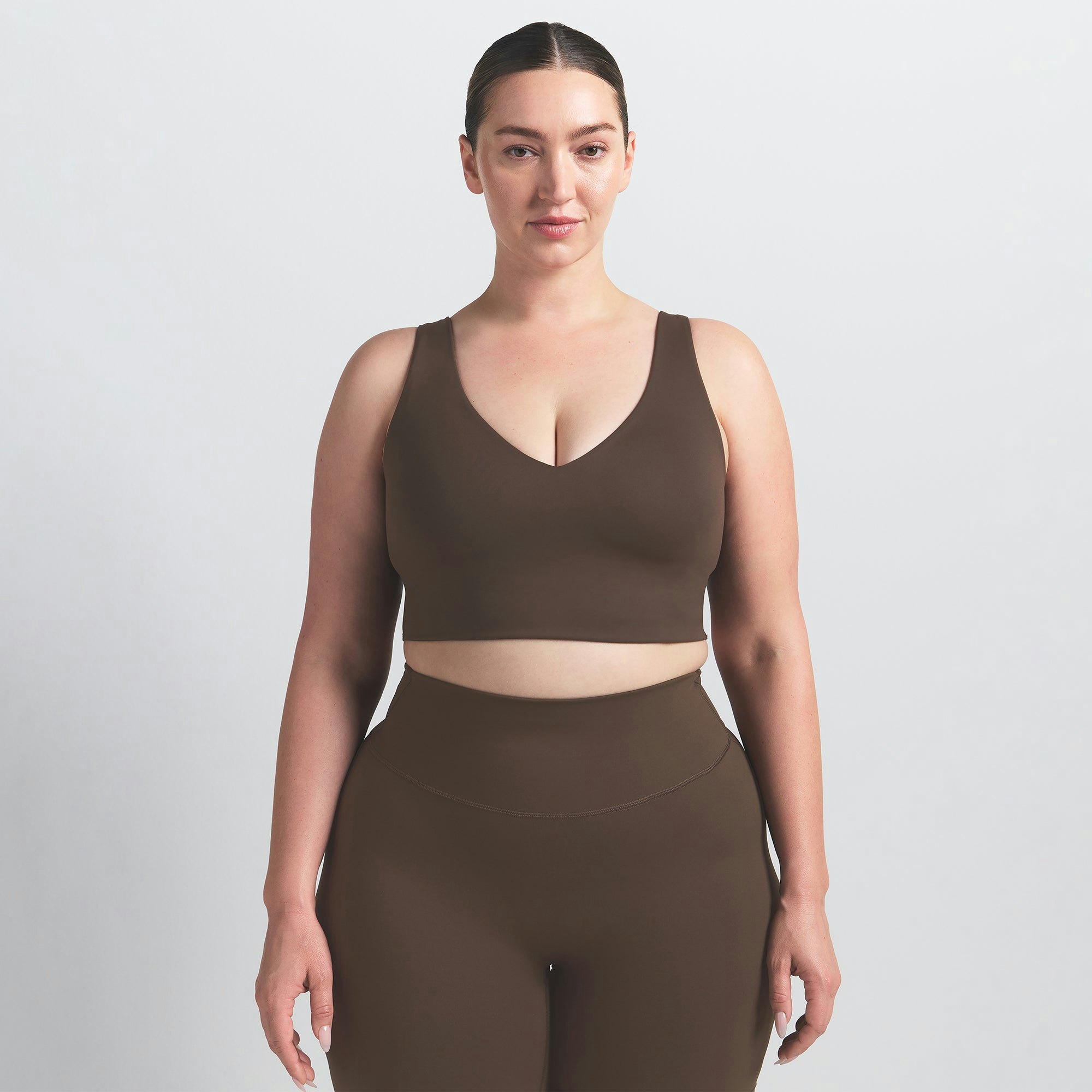 NikeSKIMS MATTE V-NECK BRA TOP | DARK SEPIA ON A MODEL FRONT VIEW
