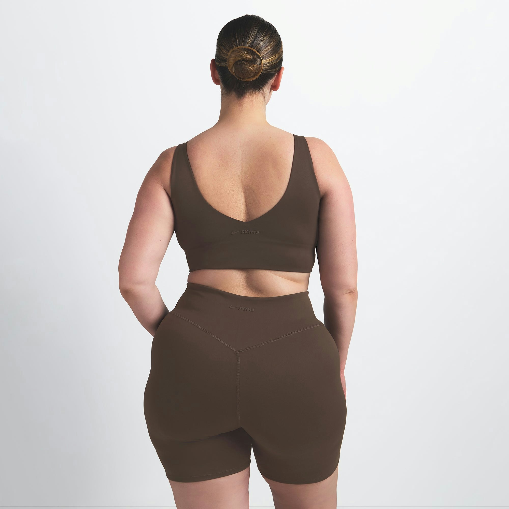 NikeSKIMS MATTE V-NECK BRA TOP | DARK SEPIA ON A MODEL BACK VIEW