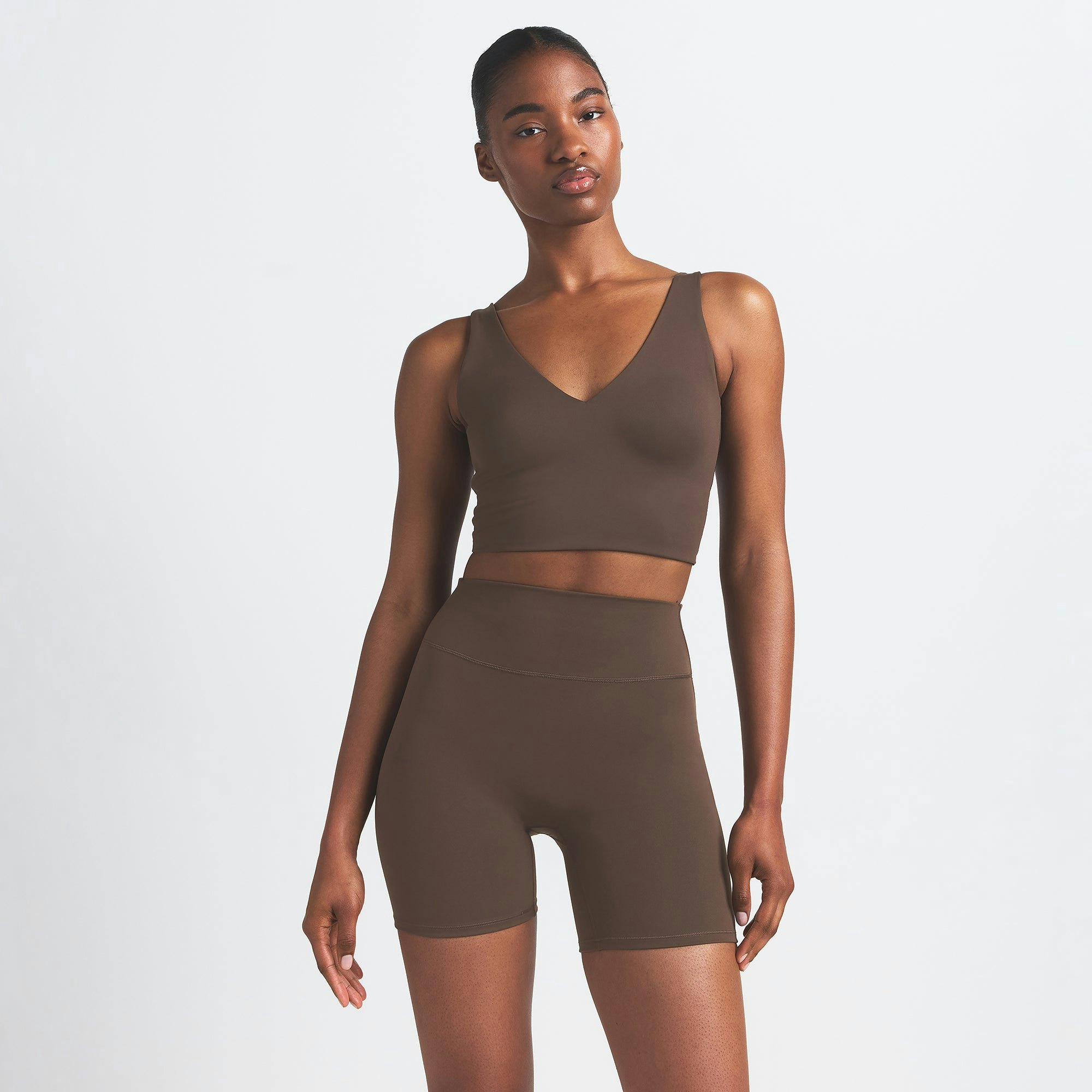 NikeSKIMS MATTE V-NECK BRA TOP | DARK SEPIA ON A MODEL FRONT VIEW
