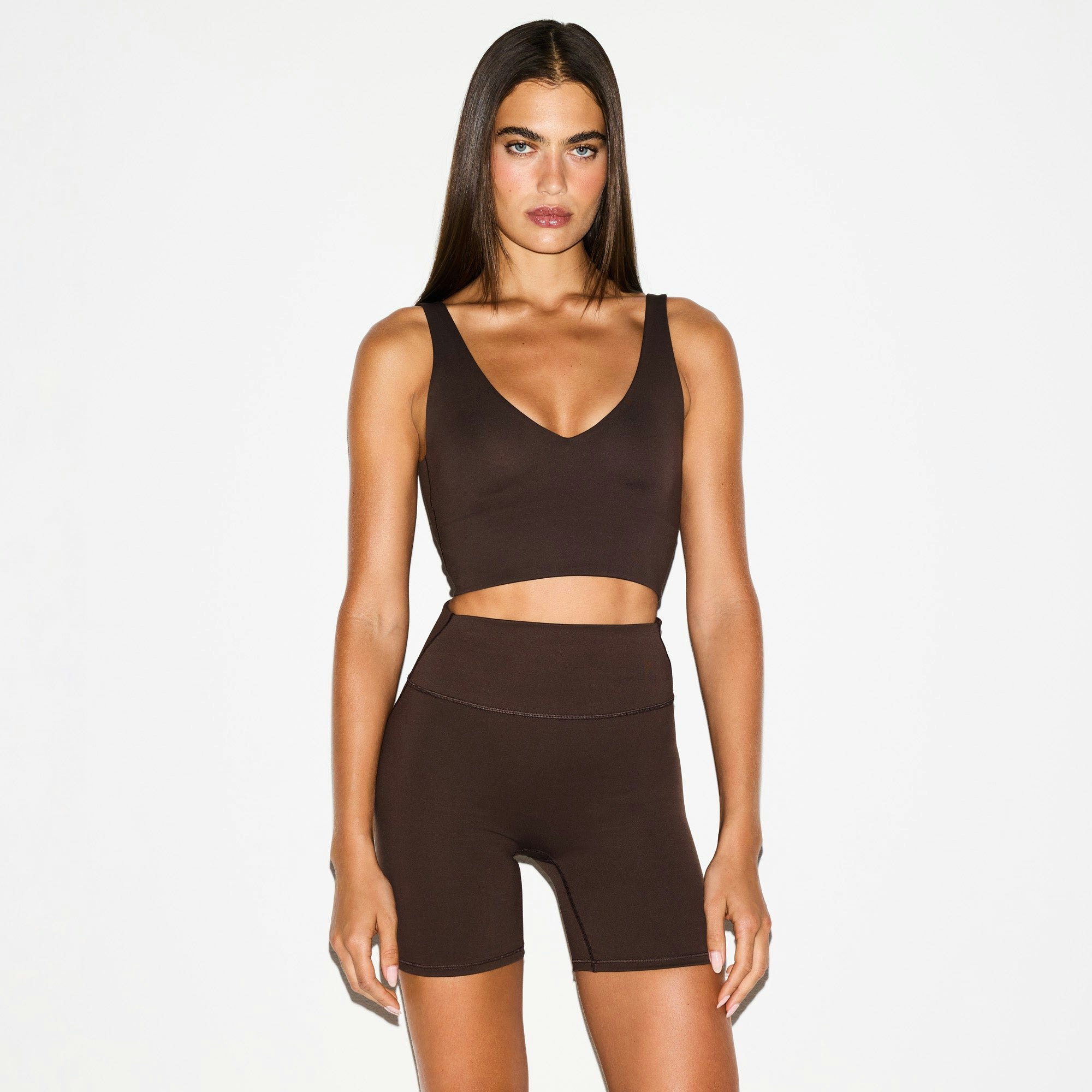 NikeSKIMS MATTE V-NECK BRA TOP | DARK SEPIA ON A MODEL FRONT VIEW @ | FOCUS: 0.0, 1.0, 0.9