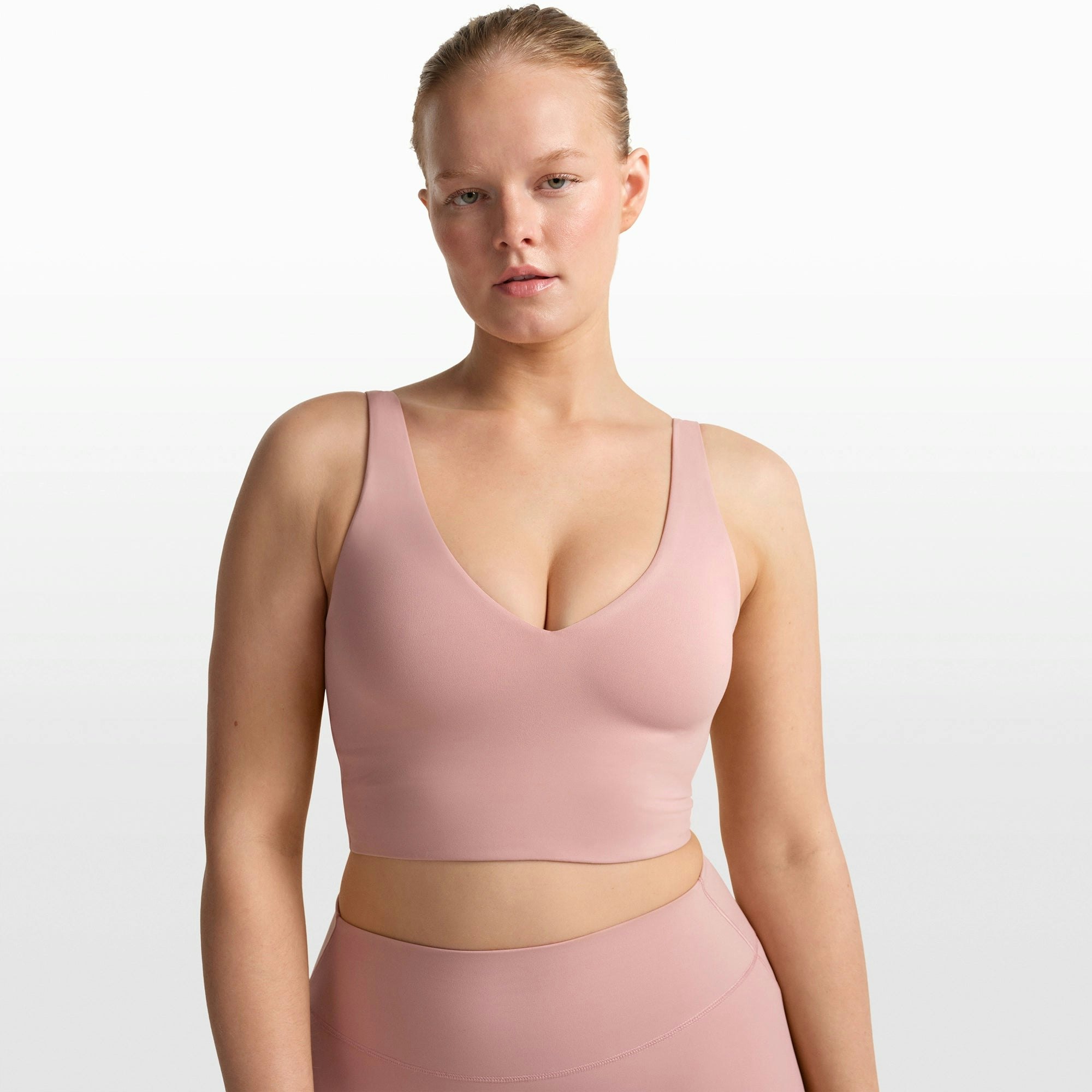 NikeSKIMS MATTE V-NECK BRA TOP | HIMALAYAN ON A MODEL FRONT VIEW @ | FOCUS: 0.0, 1.0, 0.9