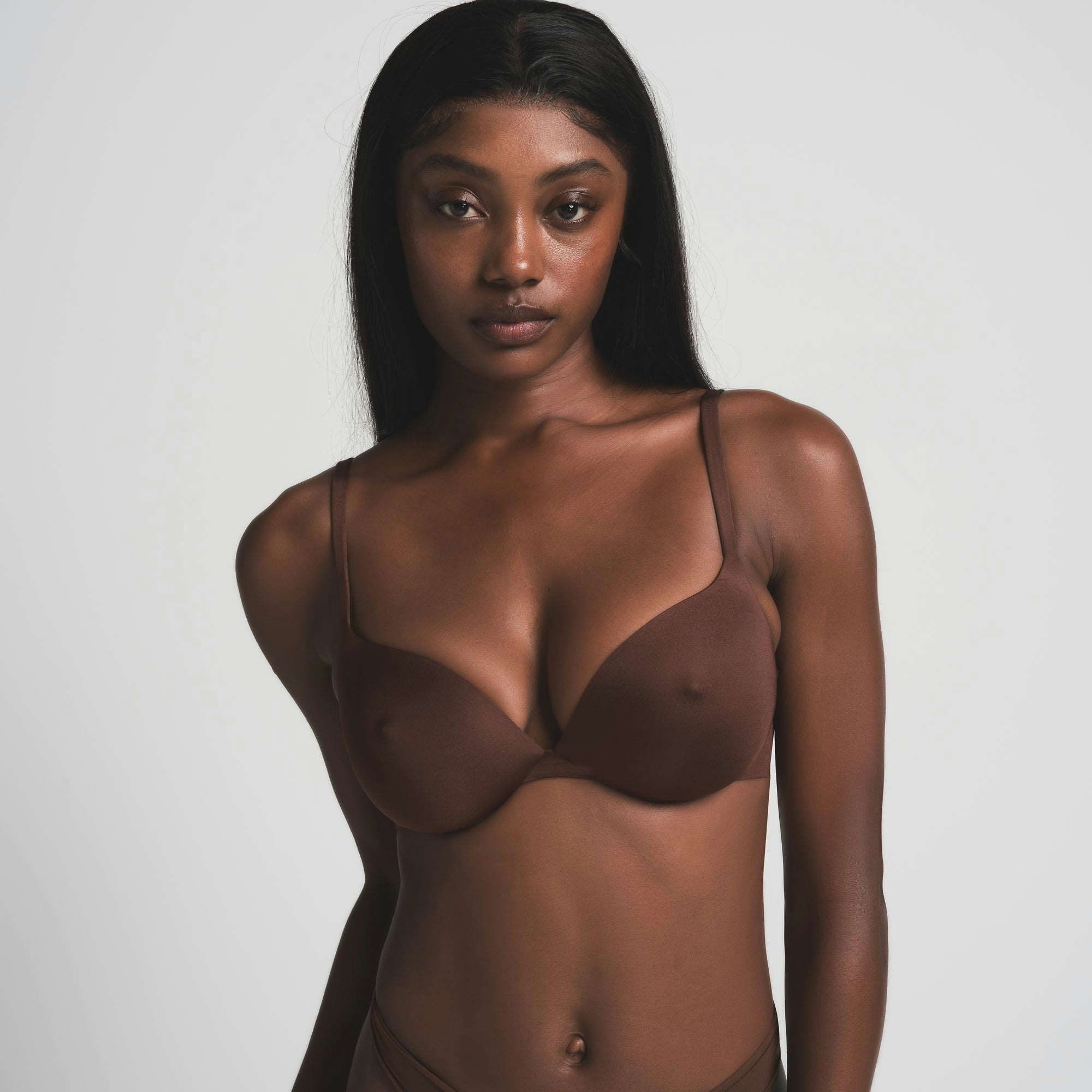 SKIMS ULTIMATE NIPPLE BRA IN COCOA ON A MODEL FRONT VIEW | FOCUS: 0.0, 1.0, 0.9