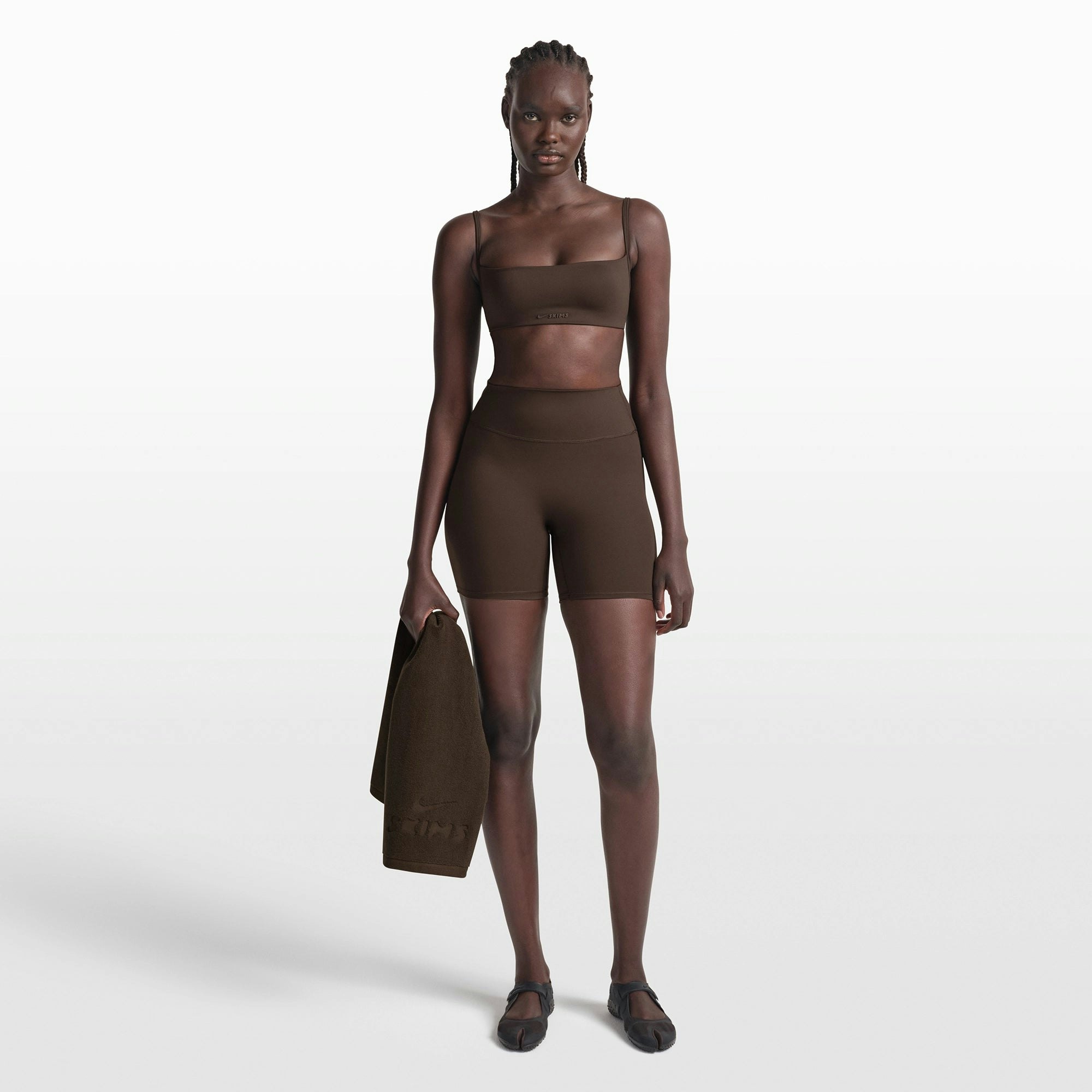 NikeSKIMS MATTE MICRO BRA | DARK SEPIA ON A MODEL FRONT VIEW @ | FOCUS: 0.0, 1.0, 0.9