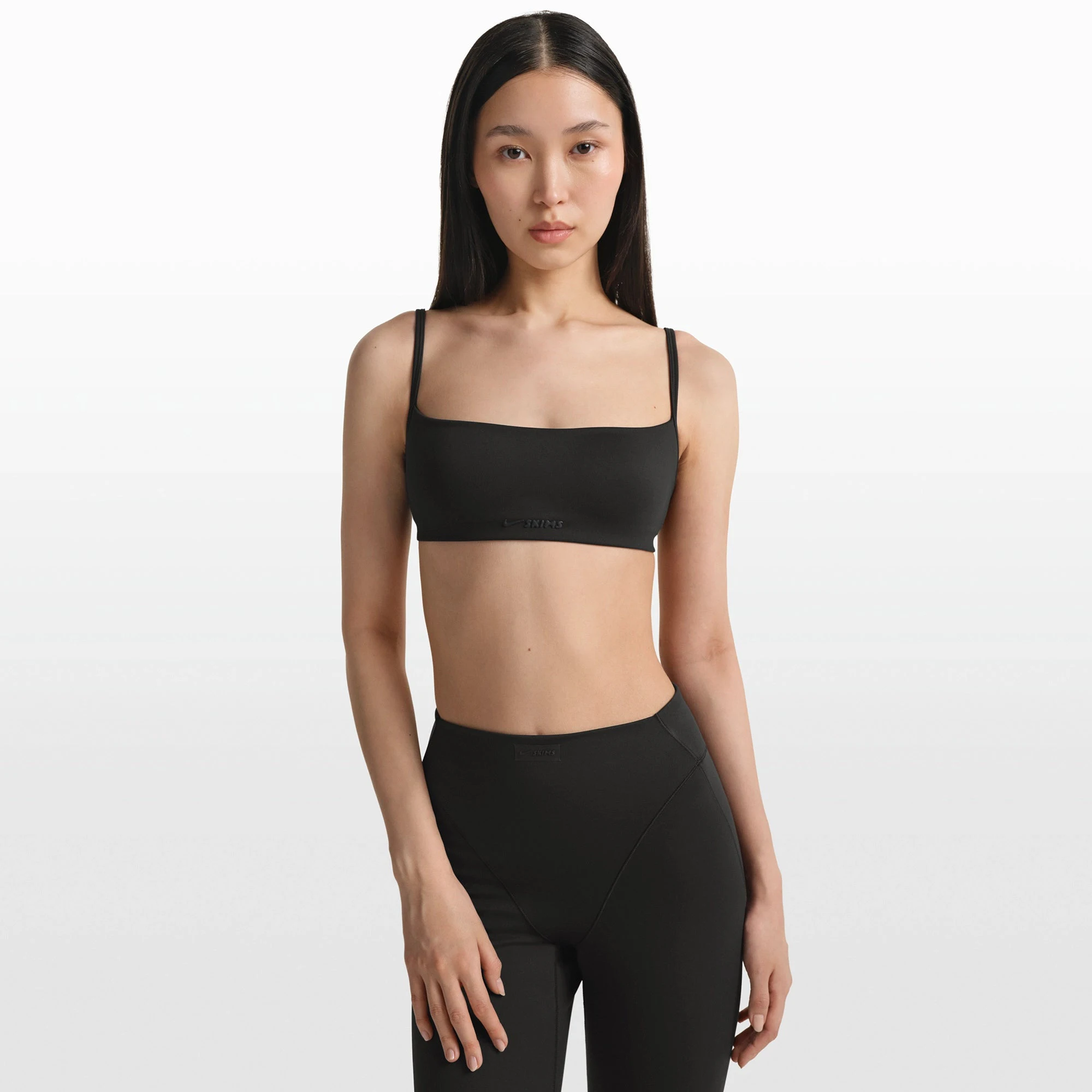 NikeSKIMS MATTE MICRO BRA | OBSIDIAN ON A MODEL FRONT VIEW @ | FOCUS: 0.0, 1.0, 0.9
