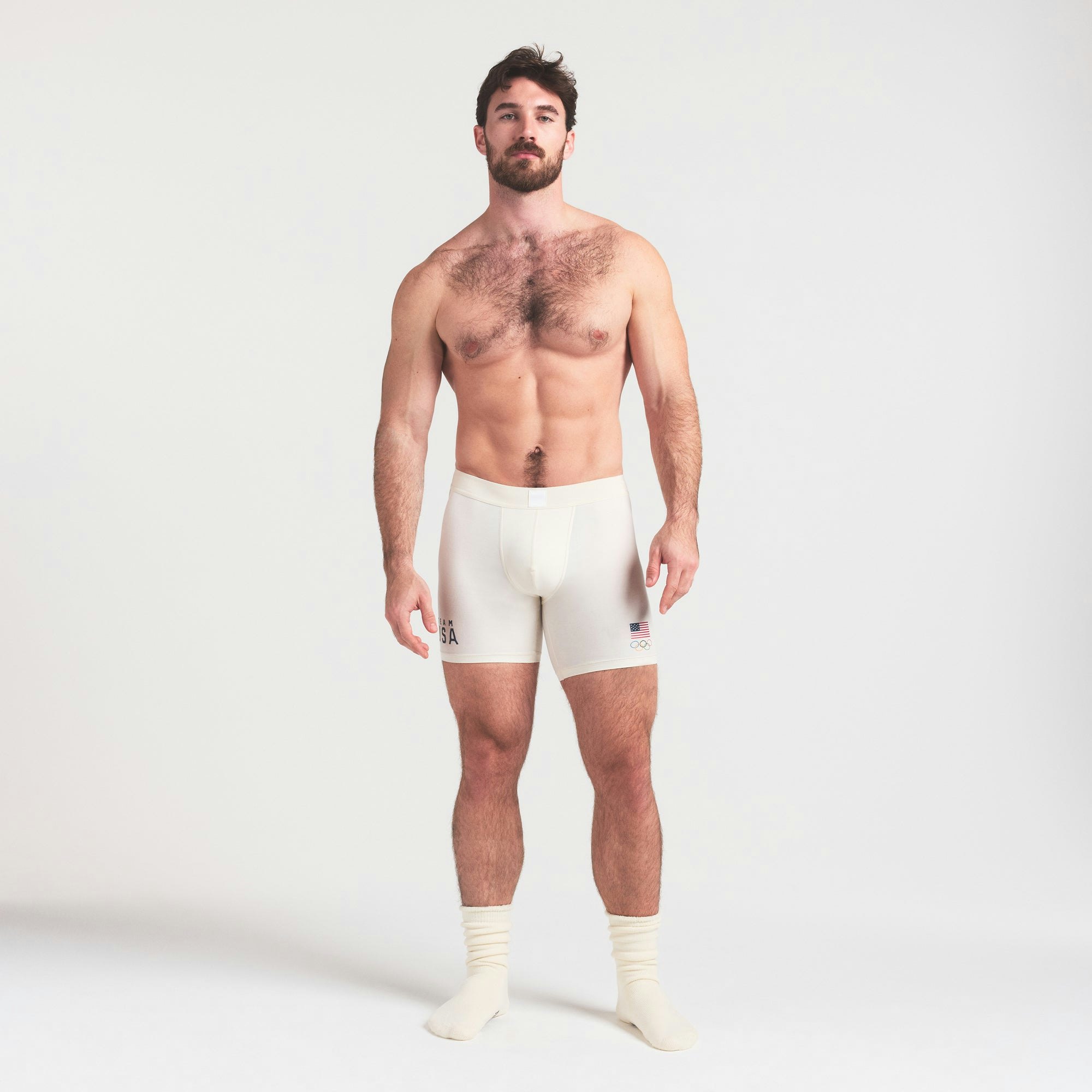 SKIMS FOR TEAM USA SKIMS COTTON MENS OLYMPIC 5 INCH BOXER BRIEF | ECRU ON A MODEL FRONT VIEW @ | FOCUS: 0.0, 1.0, 0.9