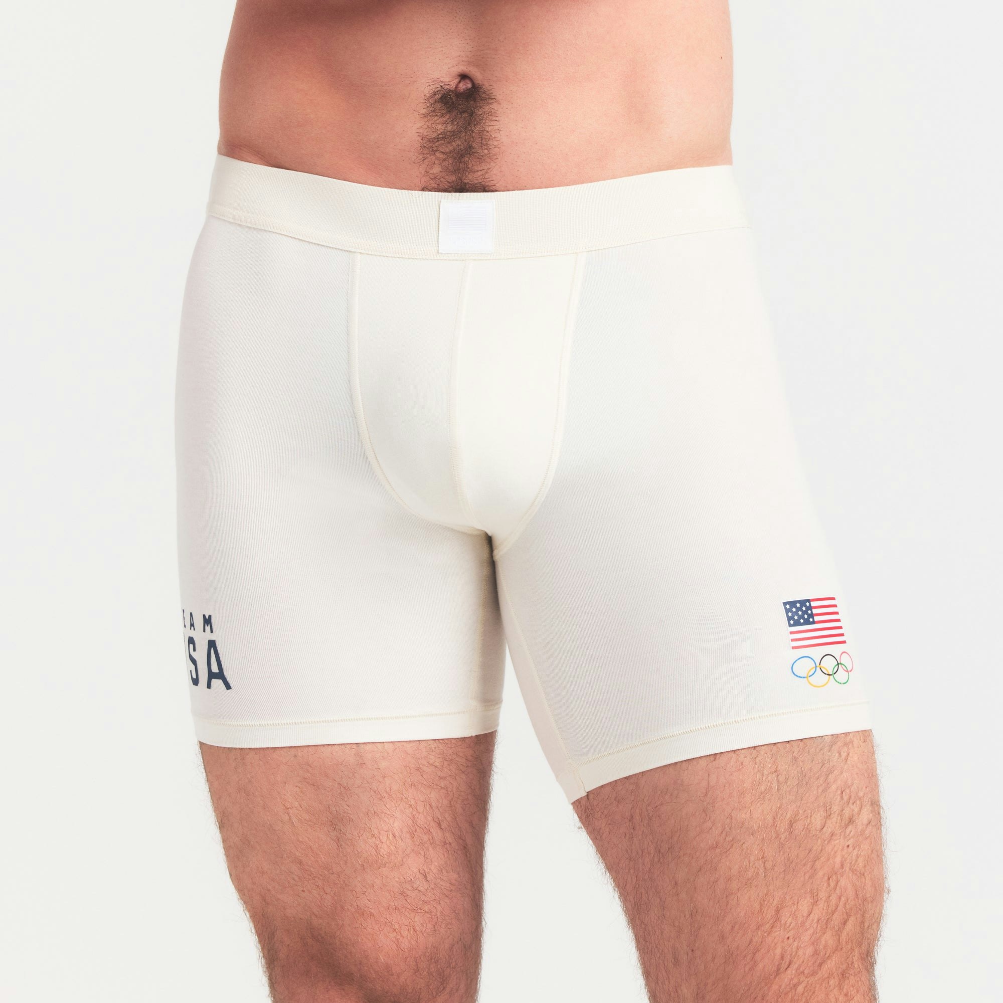 SKIMS FOR TEAM USA SKIMS COTTON MENS OLYMPIC 5 INCH BOXER BRIEF | ECRU ON A MODEL SIDE VIEW @ | FOCUS: 0.0, 1.0, 0.9