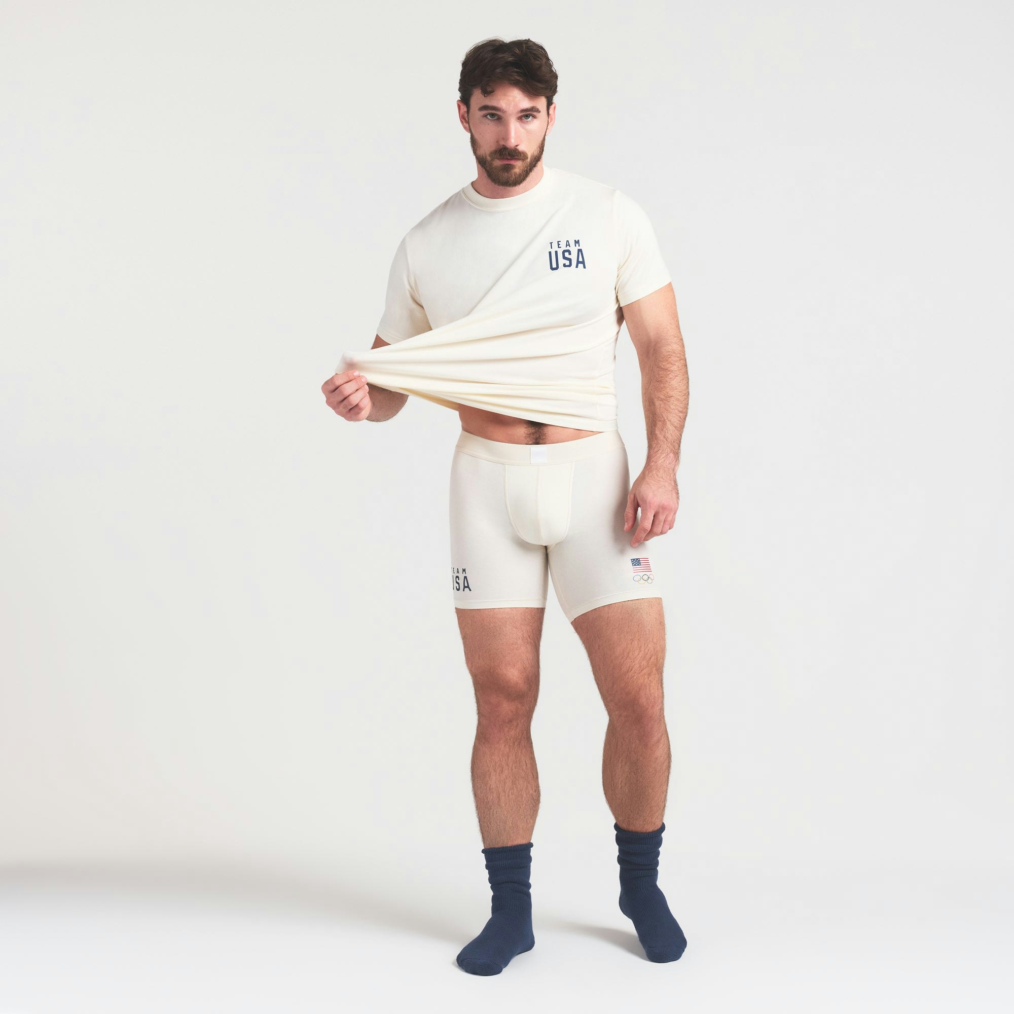 SKIMS FOR TEAM USA SKIMS COTTON MENS OLYMPIC 5 INCH BOXER BRIEF | ECRU ON A MODEL FRONT VIEW @ | FOCUS: 0.0, 1.0, 0.9