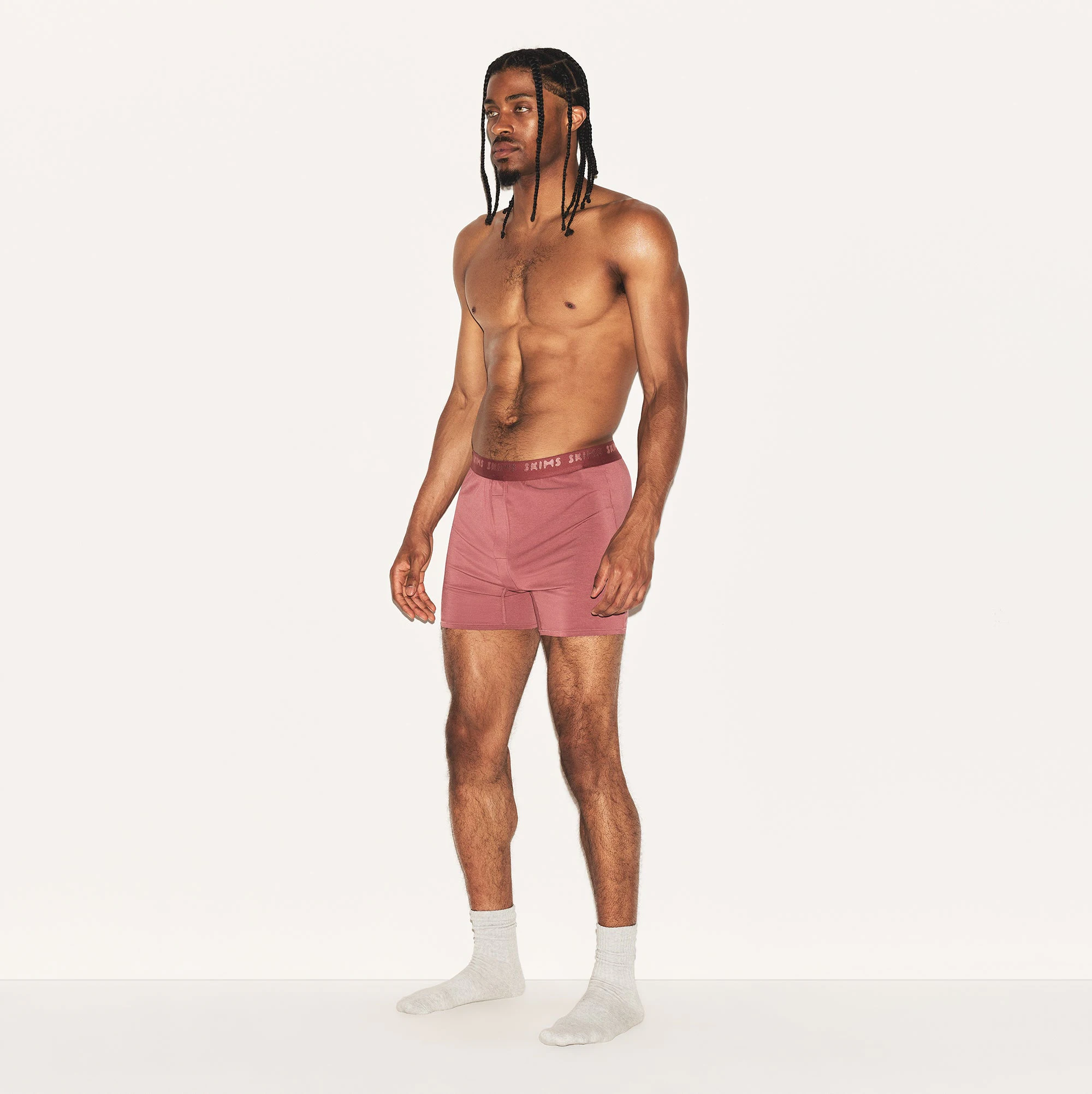 SKIMS STRETCH MENS KNIT BOXER | CORDOVAN ON A MODEL SIDE VIEW | FOCUS: 0.0, 1.0, 0.9